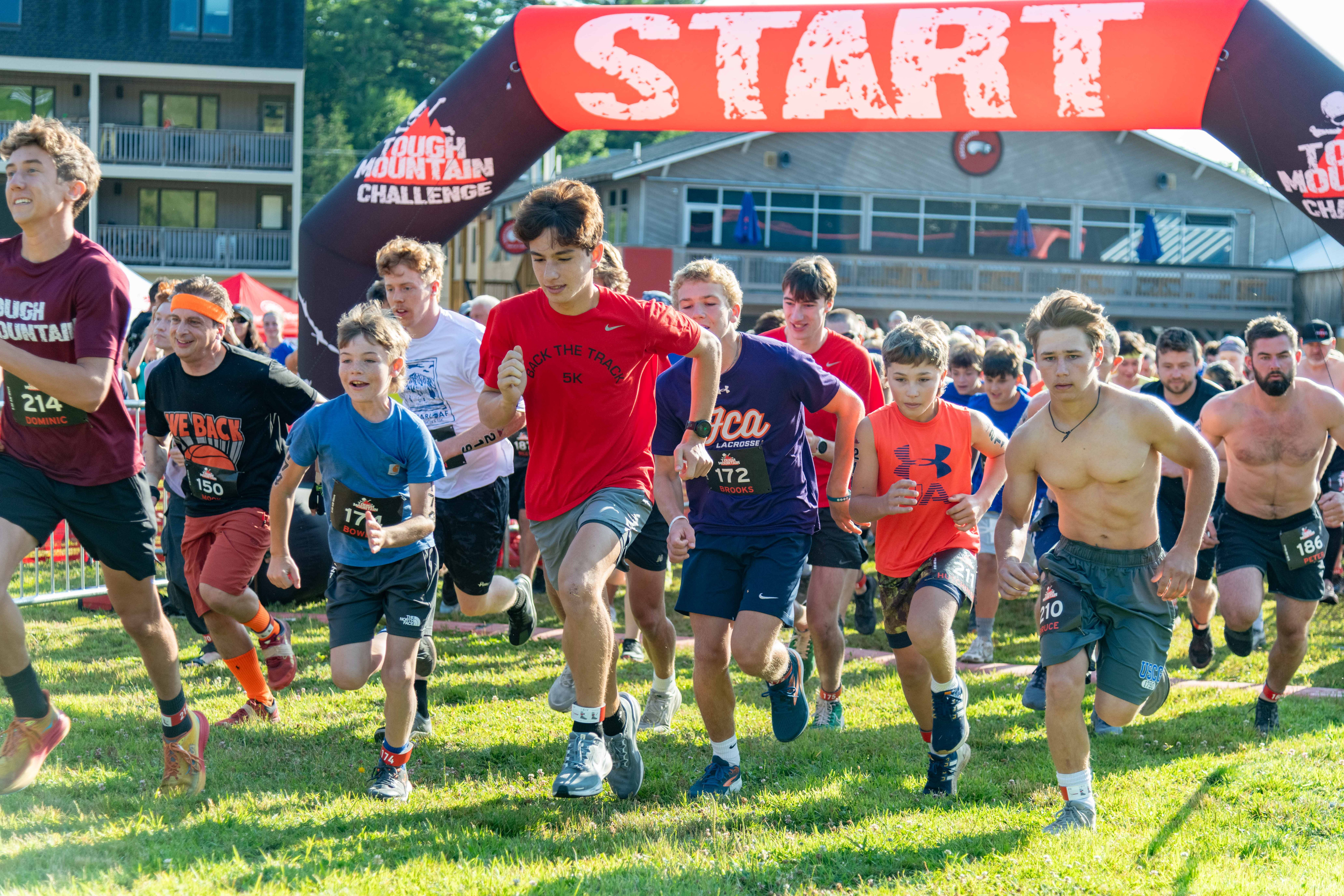 People running through the start line at Tough Mountain Challenge.