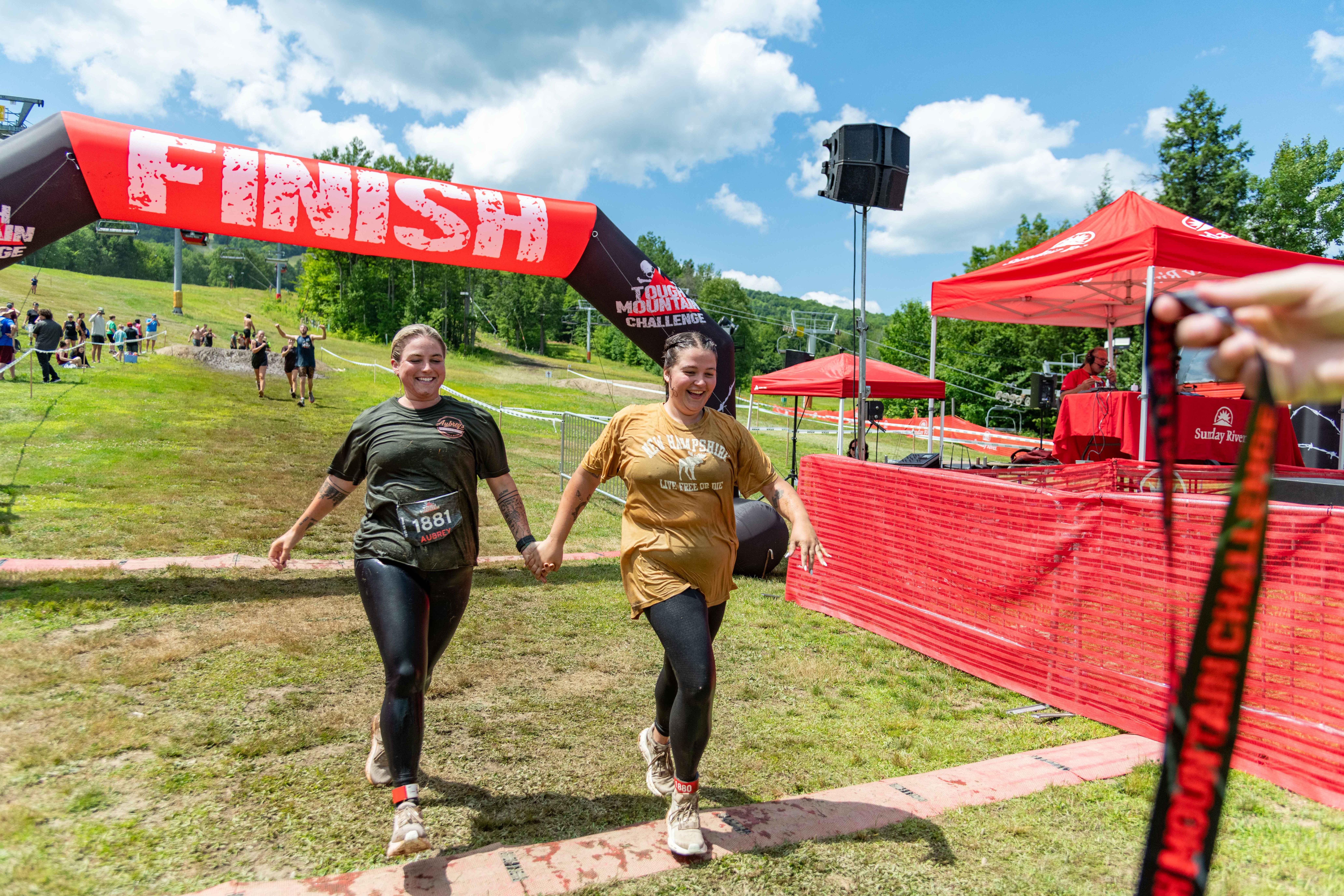 People holding hands across the finish line.