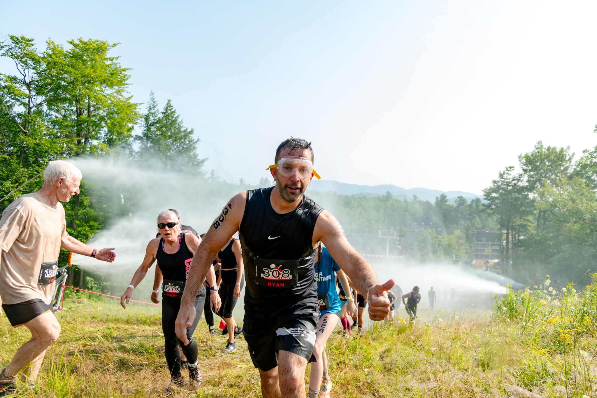 An athlete with goggled climbing up the hill at the Tough Mountain Challenge at Sunday River.