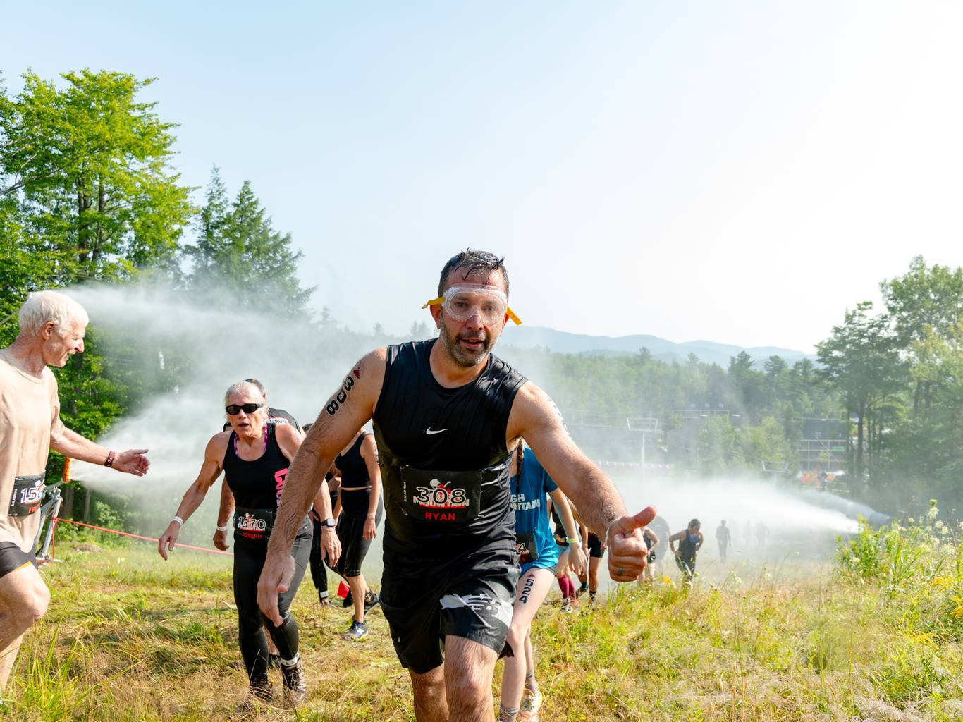 An athlete with goggled climbing up the hill at the Tough Mountain Challenge at Sunday River.