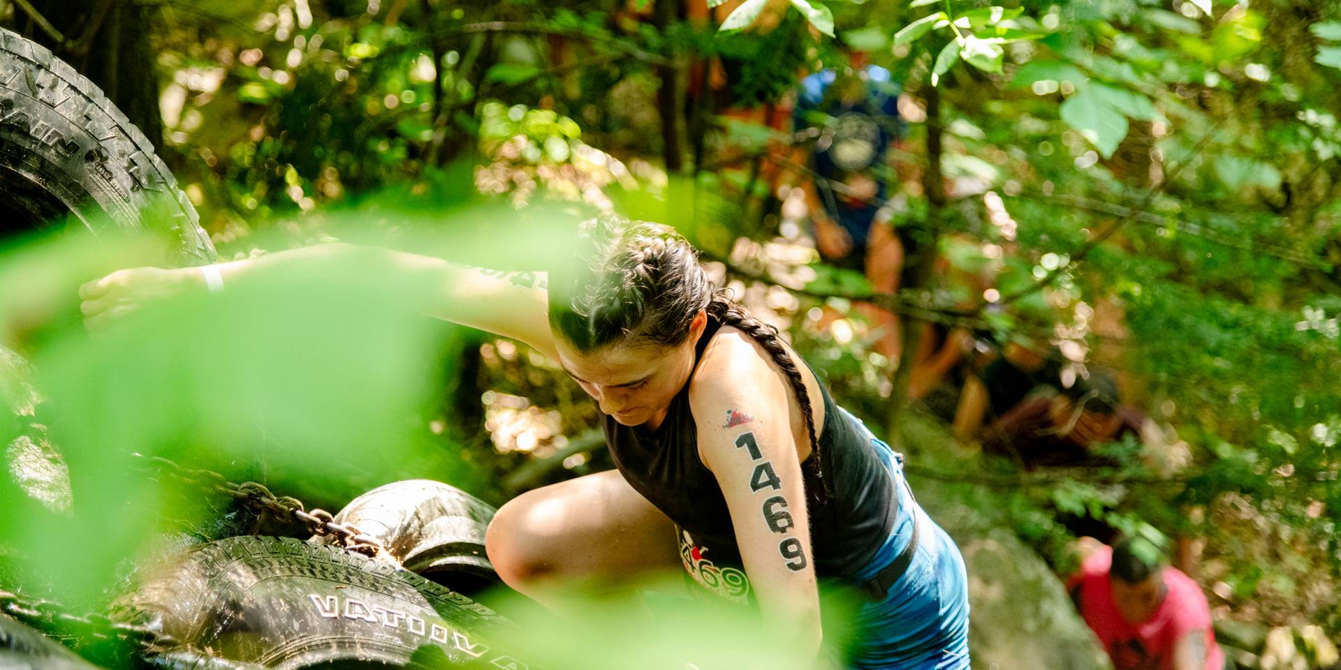 Participants of the Tough Mountain Challenge at Sunday River Resort completing an obstacle