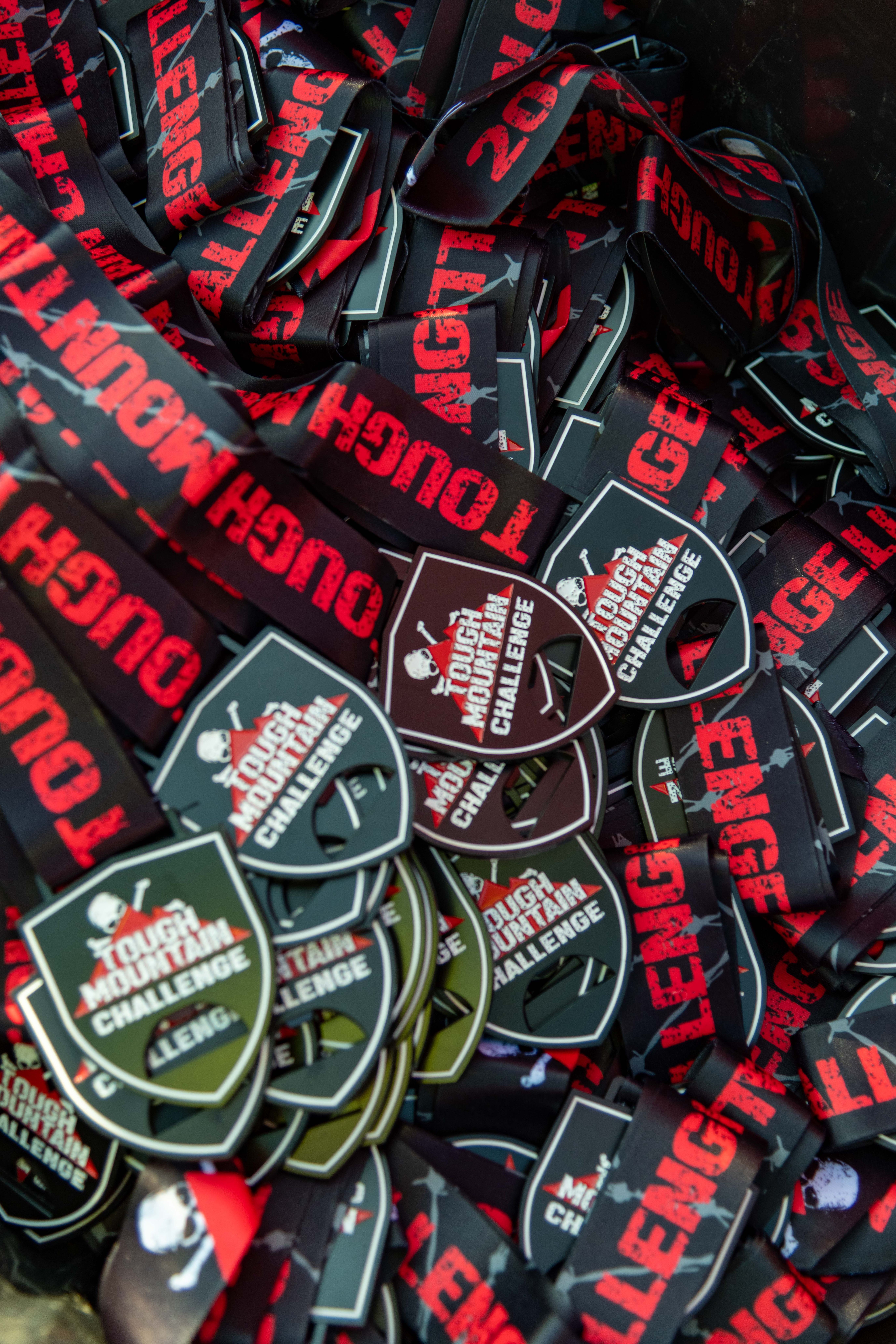 A whole bunch of Tough Mountain Challenge medals.