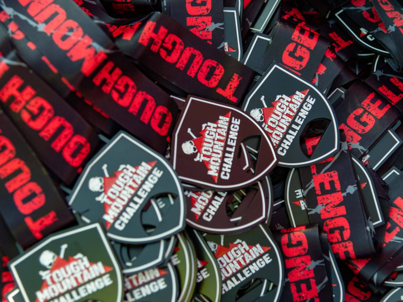 A whole bunch of Tough Mountain Challenge medals.