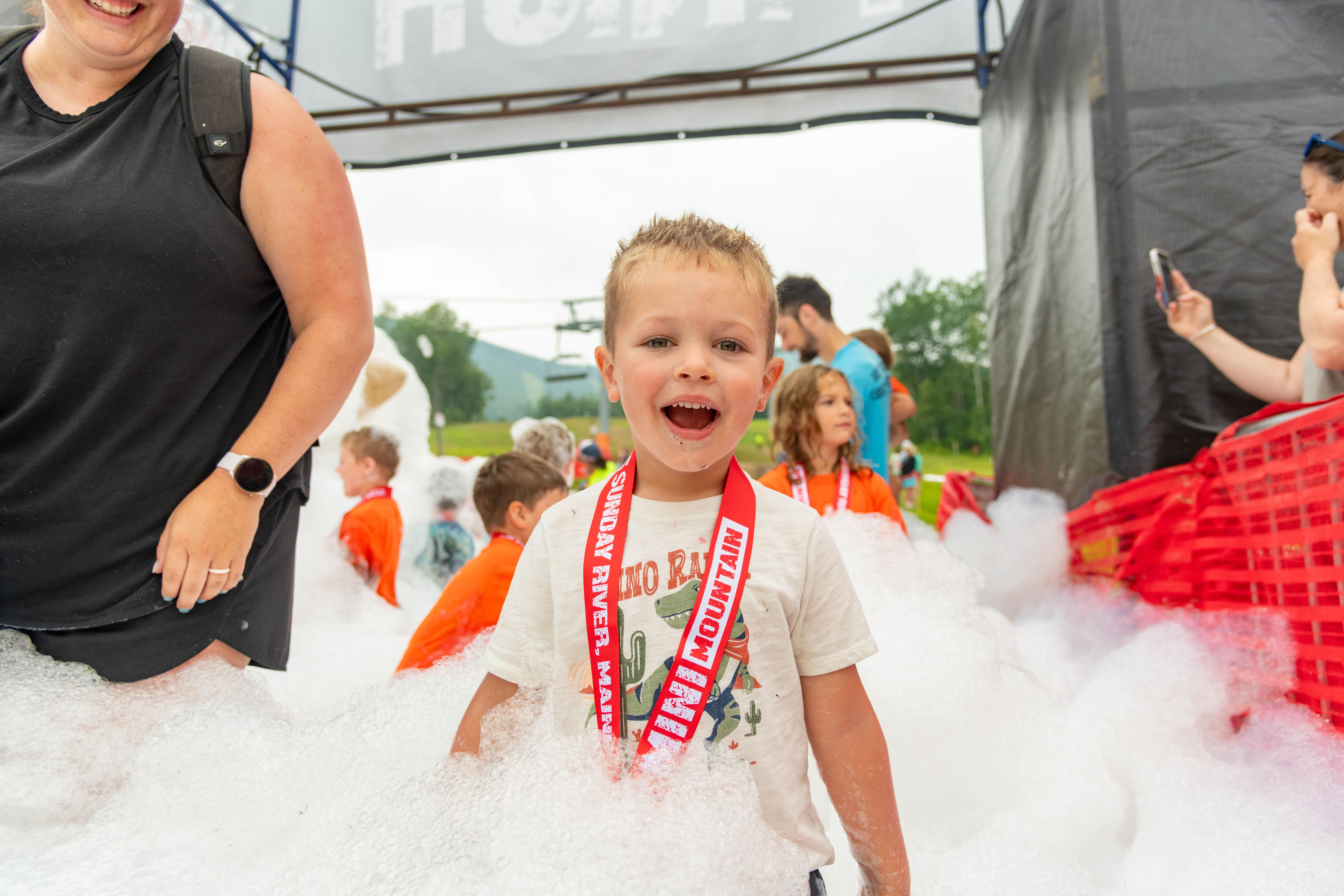 Mini Mountain Challenge competitor receiving his medal.