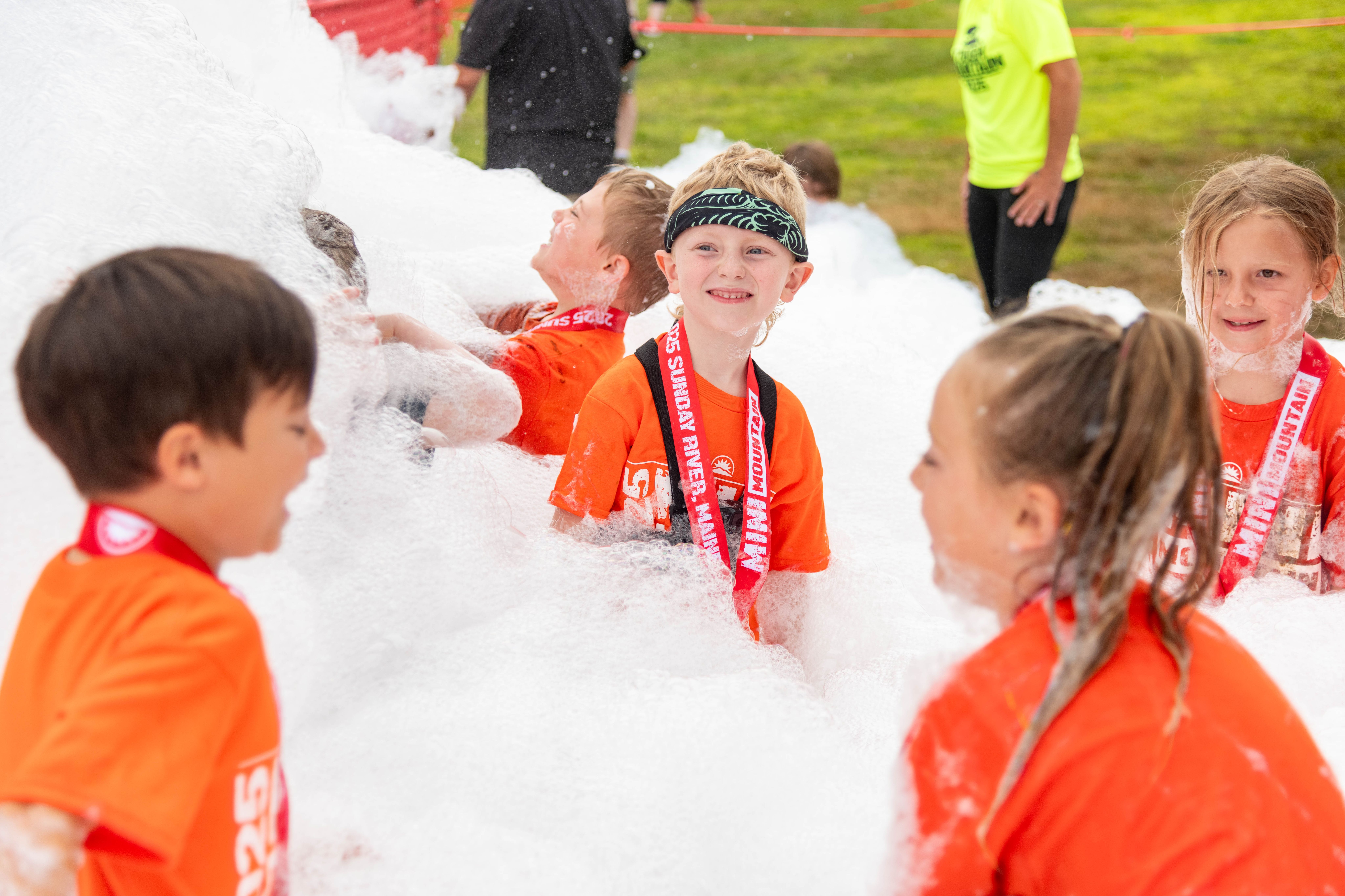 Mini Mountain Challenge racer playing in the foam.