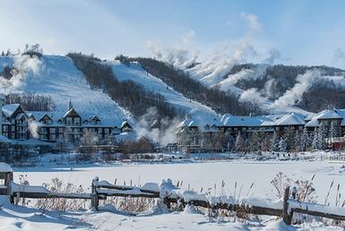 Snowy resort at the base of a mountain.