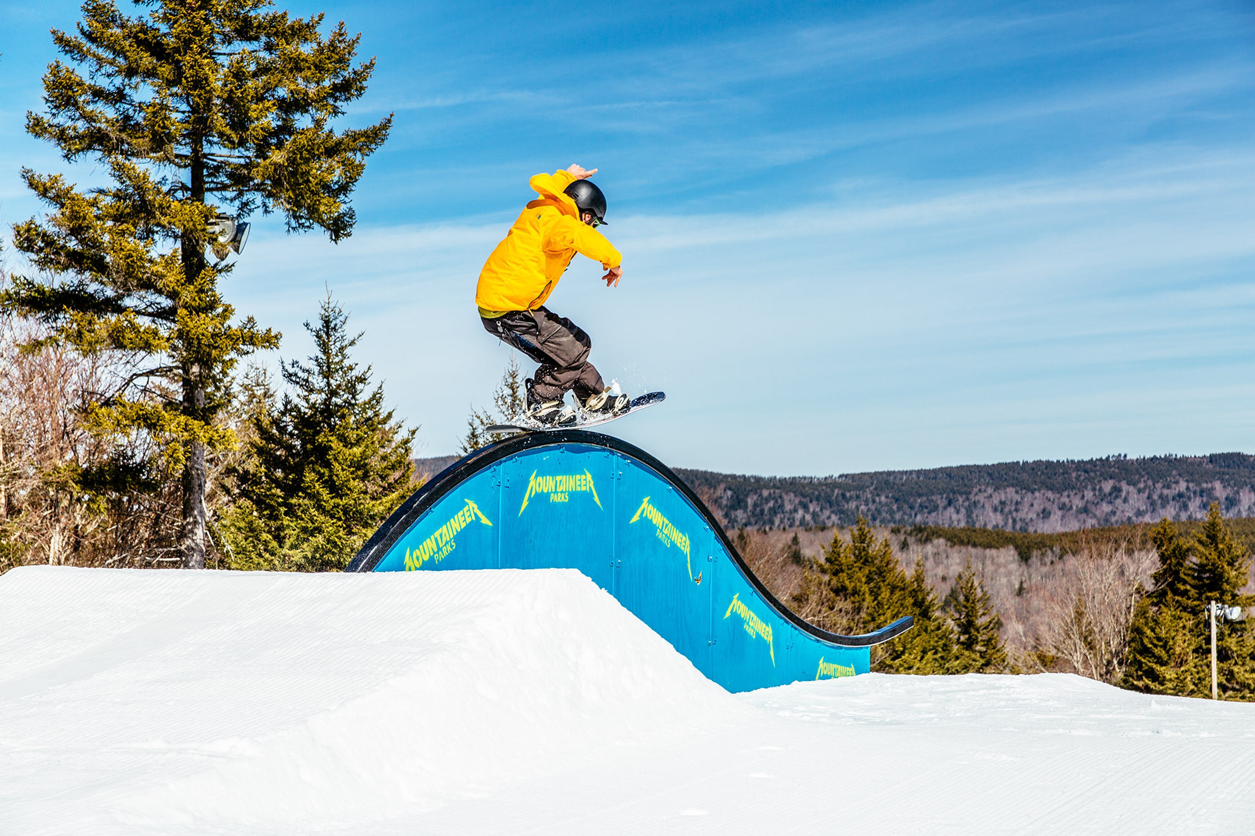 group of people skiing and snowboarding on a groomed run