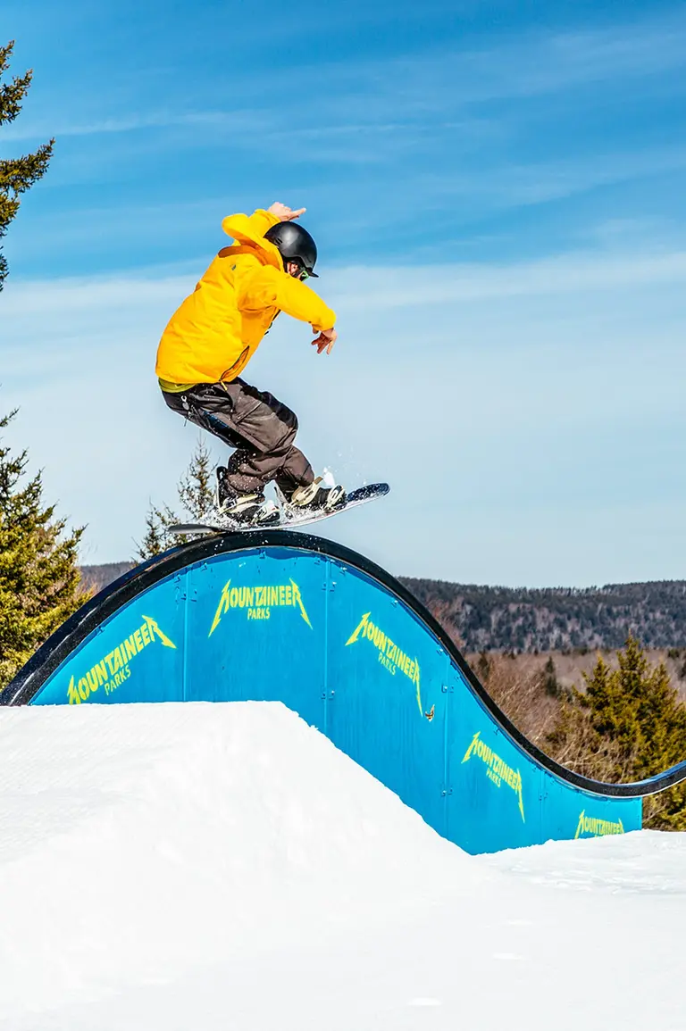group of people skiing and snowboarding on a groomed run