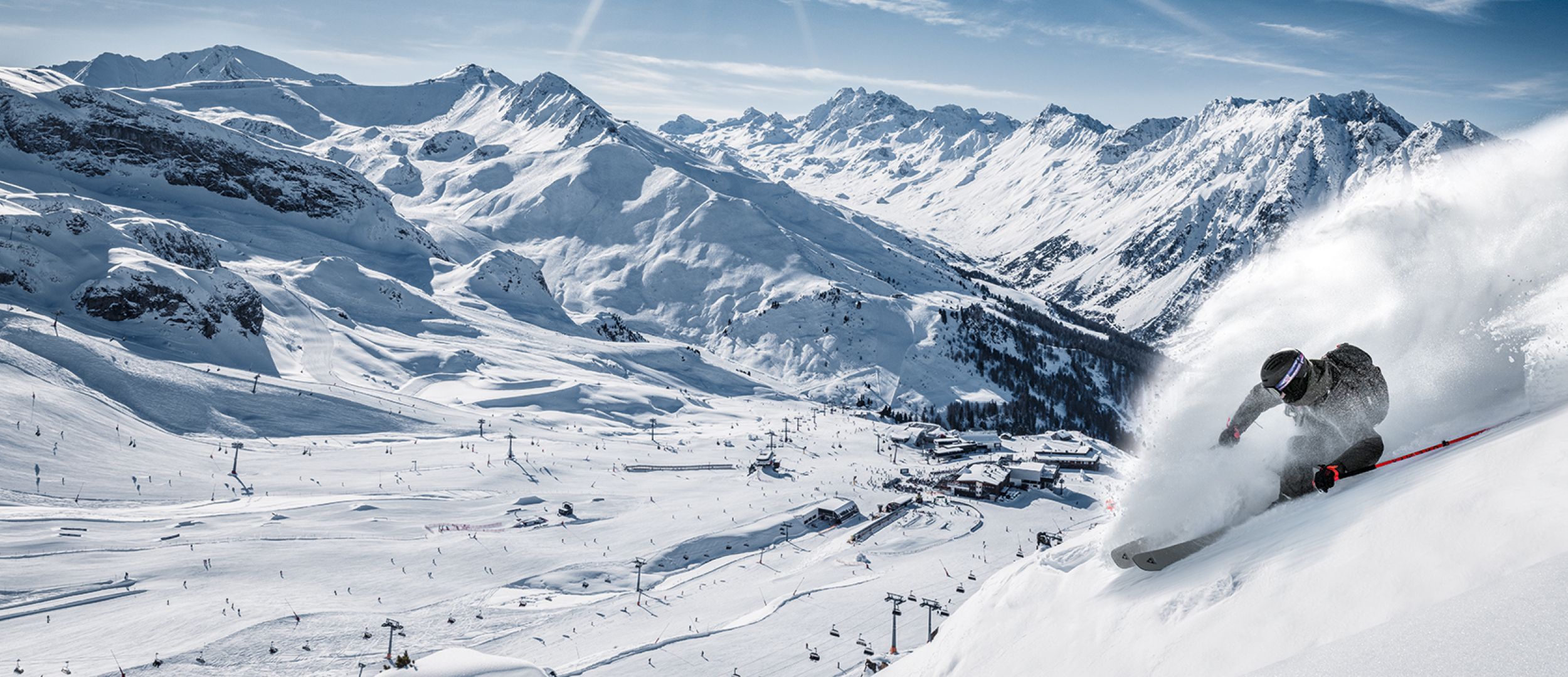 Skier going down a groomed ski run