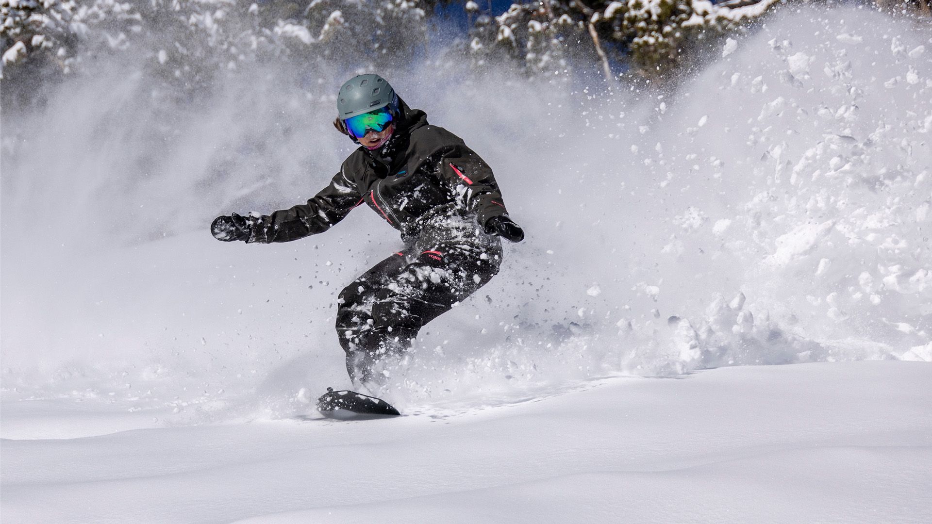 Snowboarder going through powder