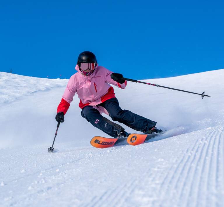 Skier enjoying deep powder in Honeycomb Canyon on a bluebird midweek day