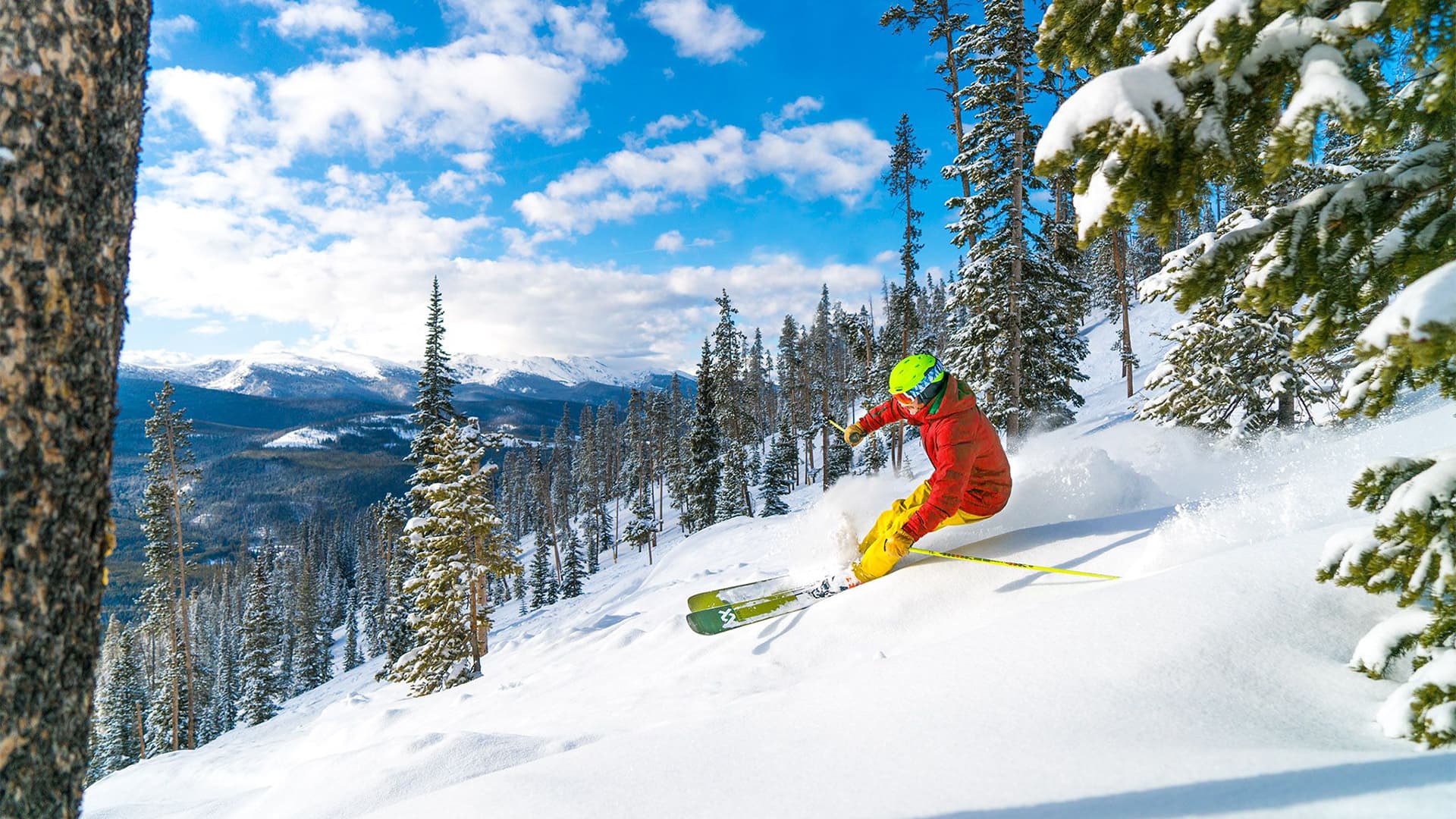 Adventurous skier descending a mountain covered in pristine powder snow.