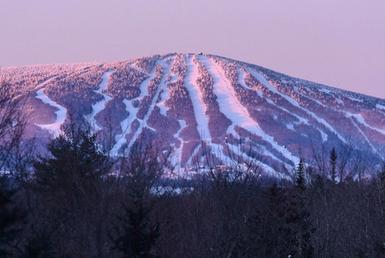 Aerial view of mountain showcasing ski trails.