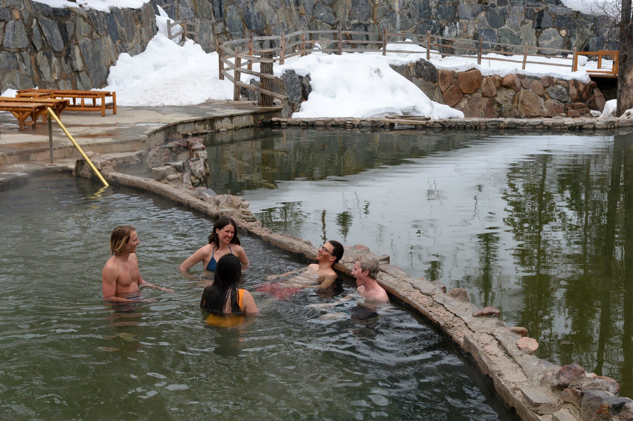 People enjoying a mountain hot spring in winter