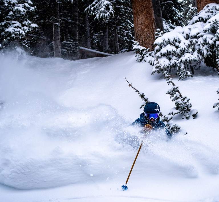 Skier enjoying deep powder in Honeycomb Canyon on a bluebird midweek day