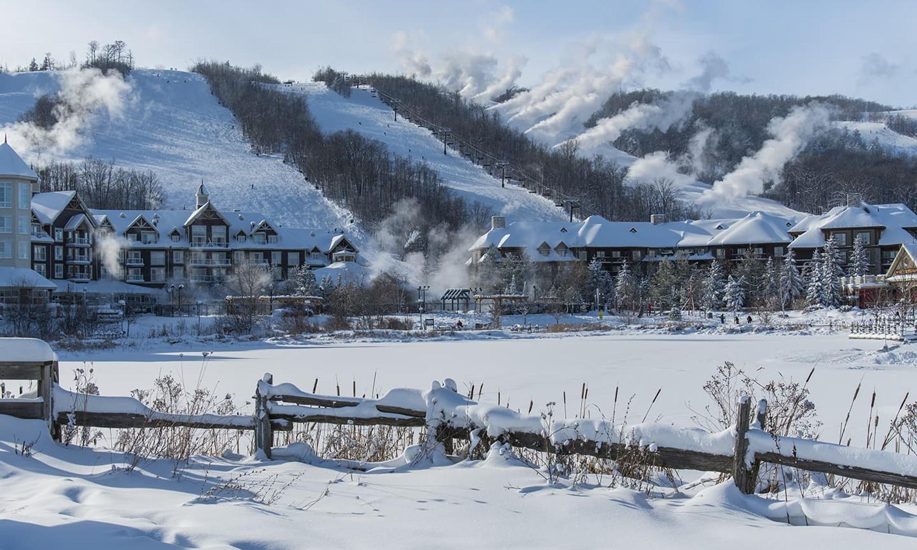 Winter landscape of resort at the base of a mountain.
