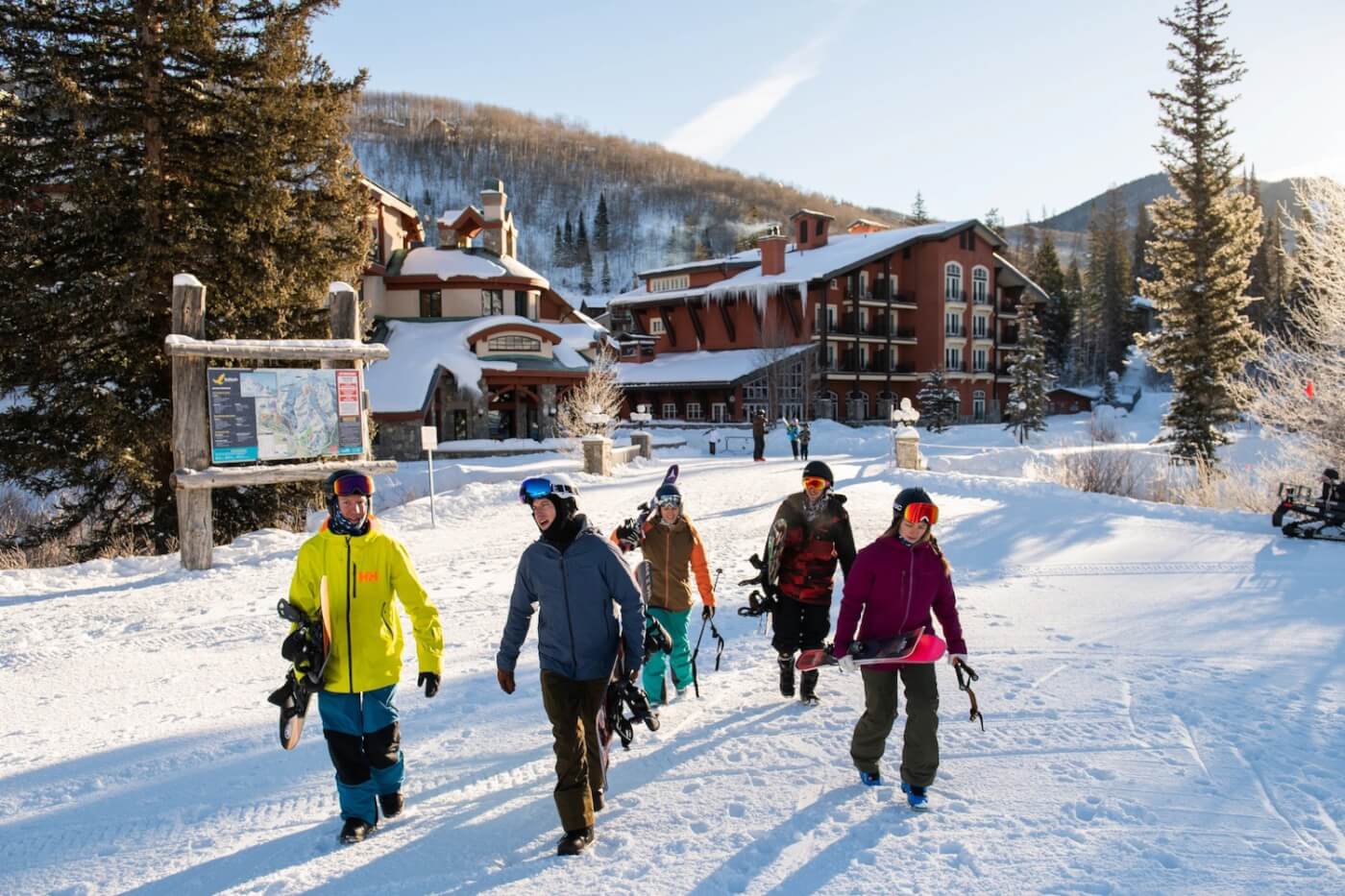 Group walks to the mountain with gear. 
