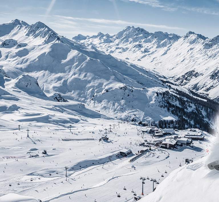 Skier going down a groomed ski run
