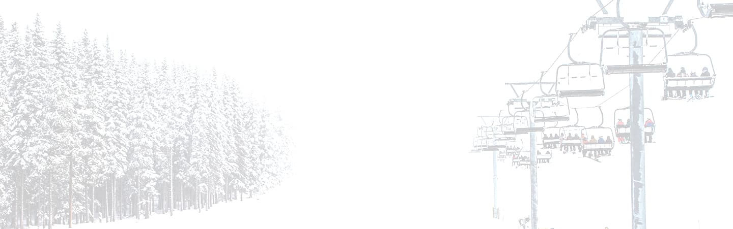 High contrast image of a chairlift surrounded by trees.