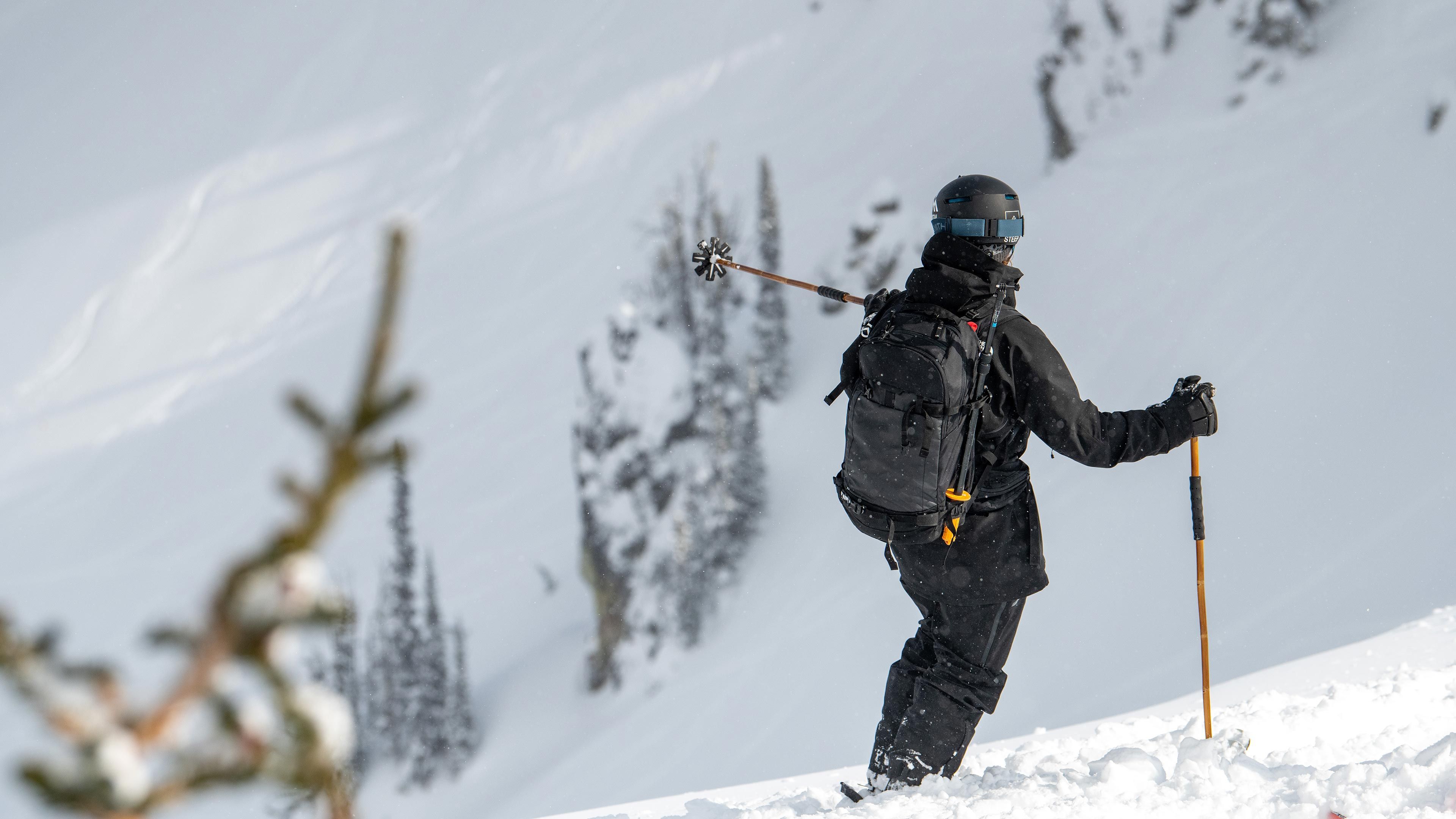 skier going down a steep run on a sunny day