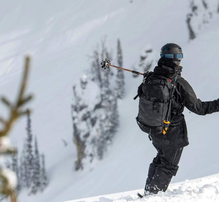 skier going down a steep run on a sunny day