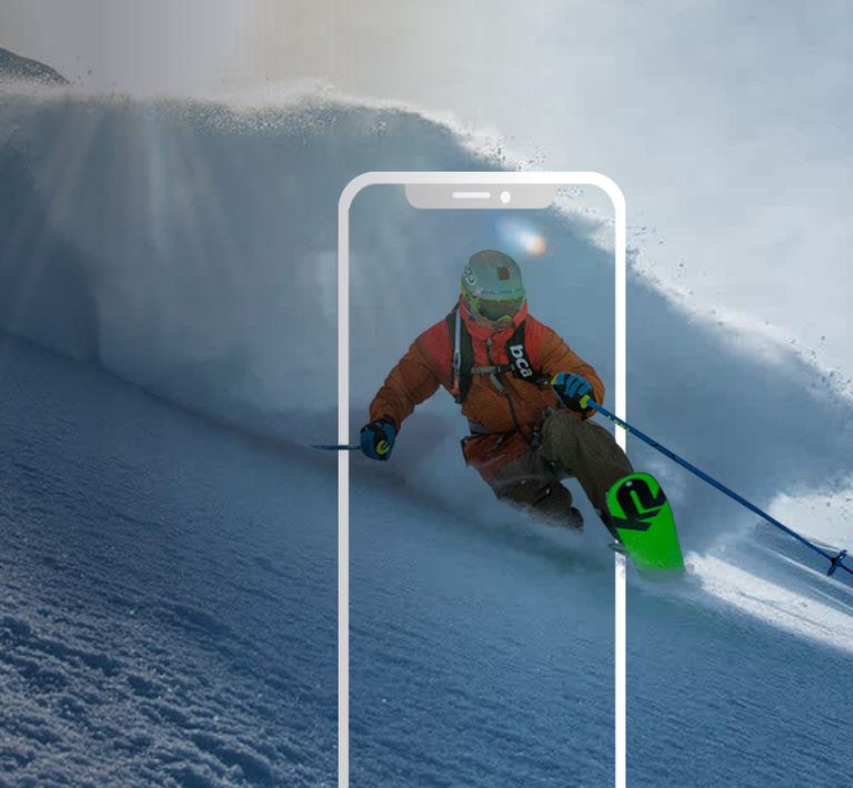 Skier enjoying the thrill of fresh powder as they carve down a mountainside.