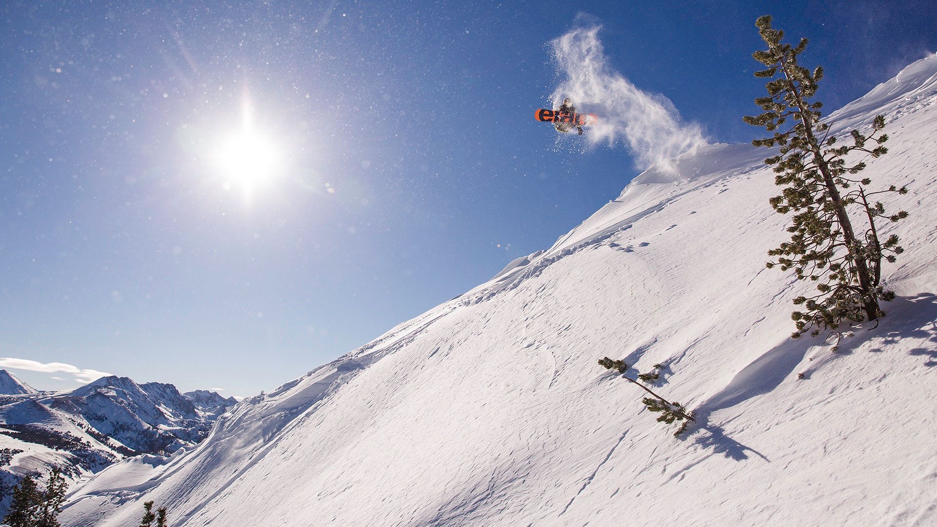 An impressive aerial maneuver by a snowboarder catching big air.