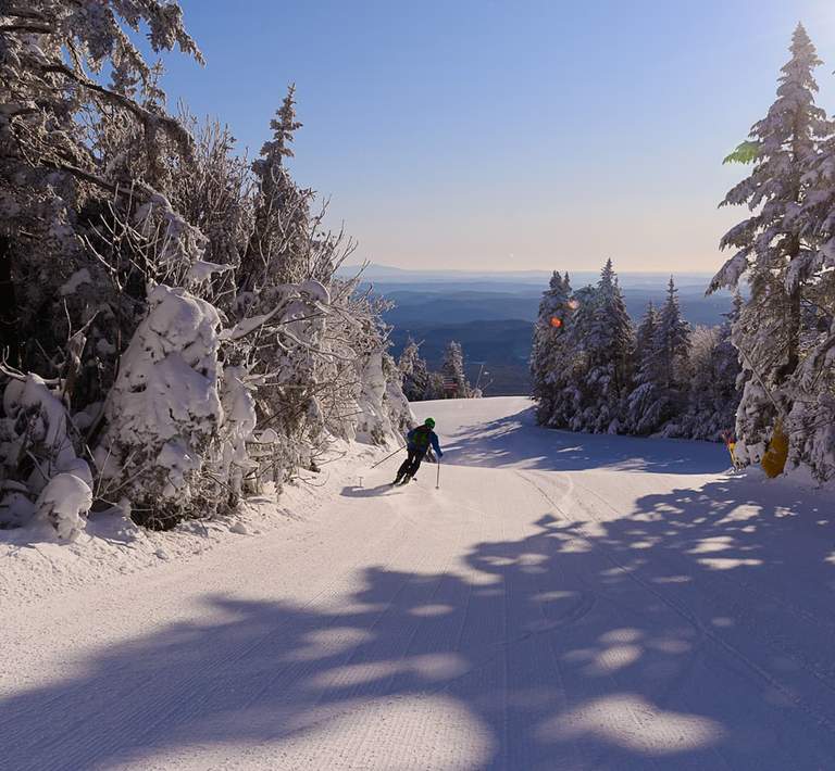 Skier making tracks on a downhill run.