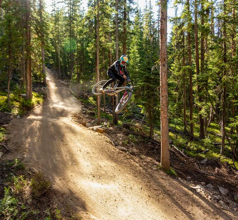 Mountain biker going off jump at Trestle Bike Park