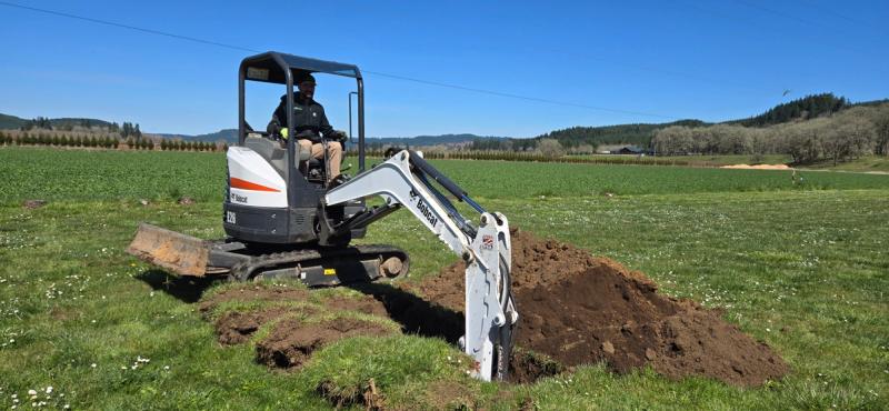 Excavating a soil test hole for site evaluation