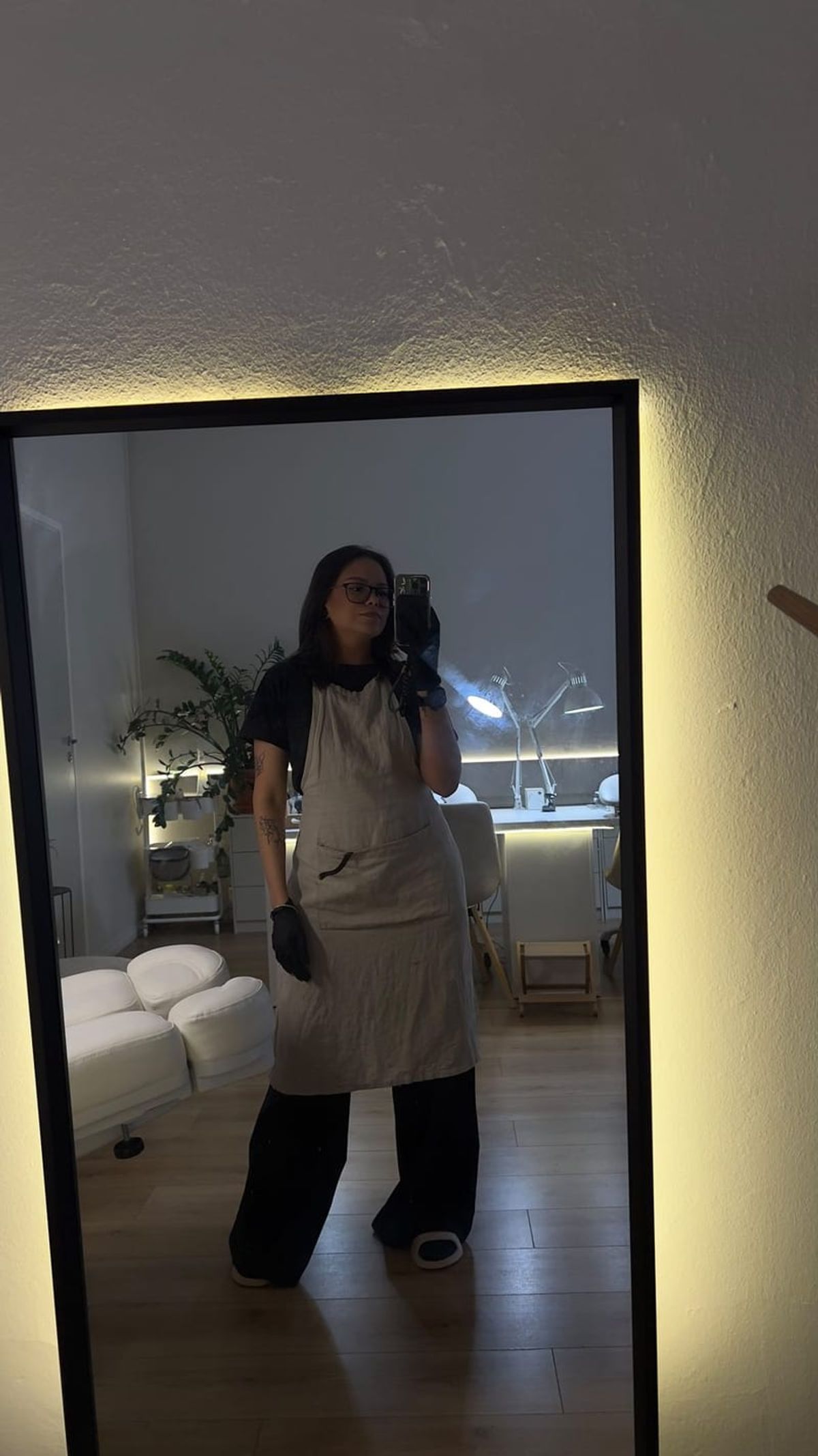 Linda in a work apron, photographed in a mirror