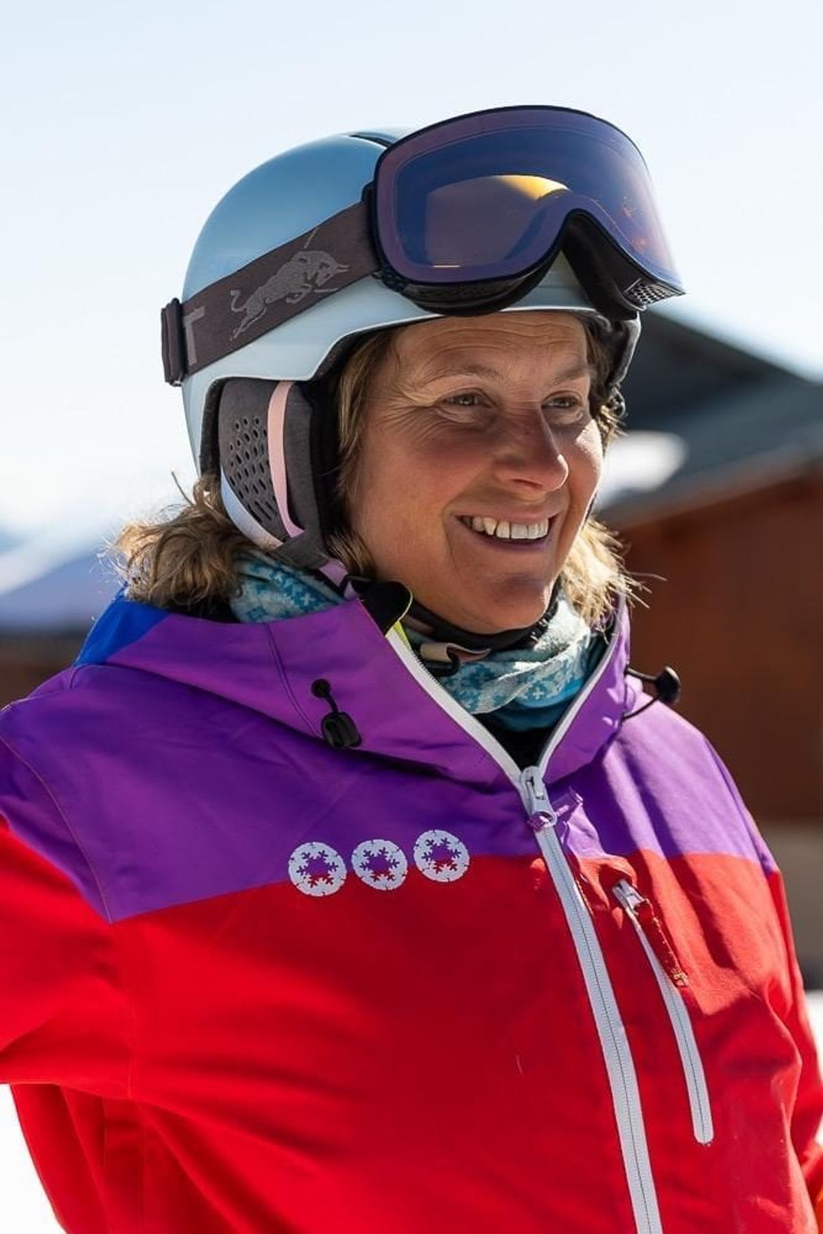 Cath in a ski school jacket and helmet on the mountain