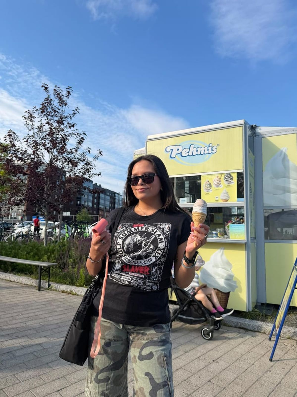 Linda outdoors on a sunny street holding an ice cream