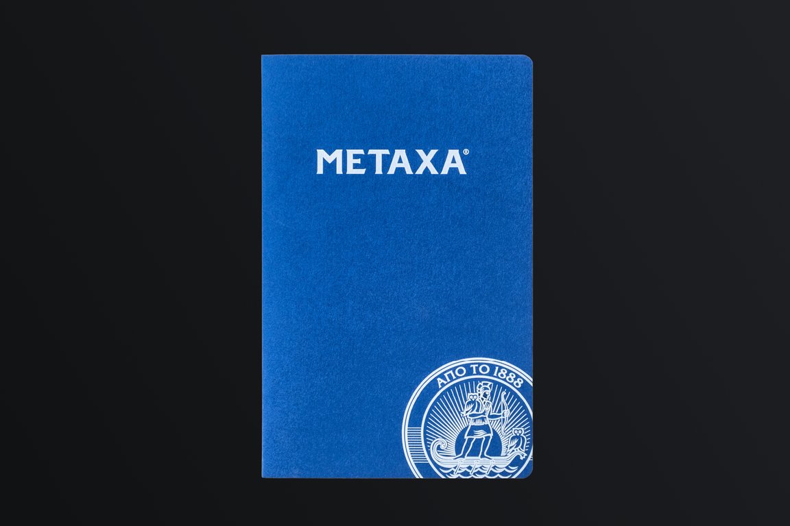 Blue corporate notebook with the Metaxa logo