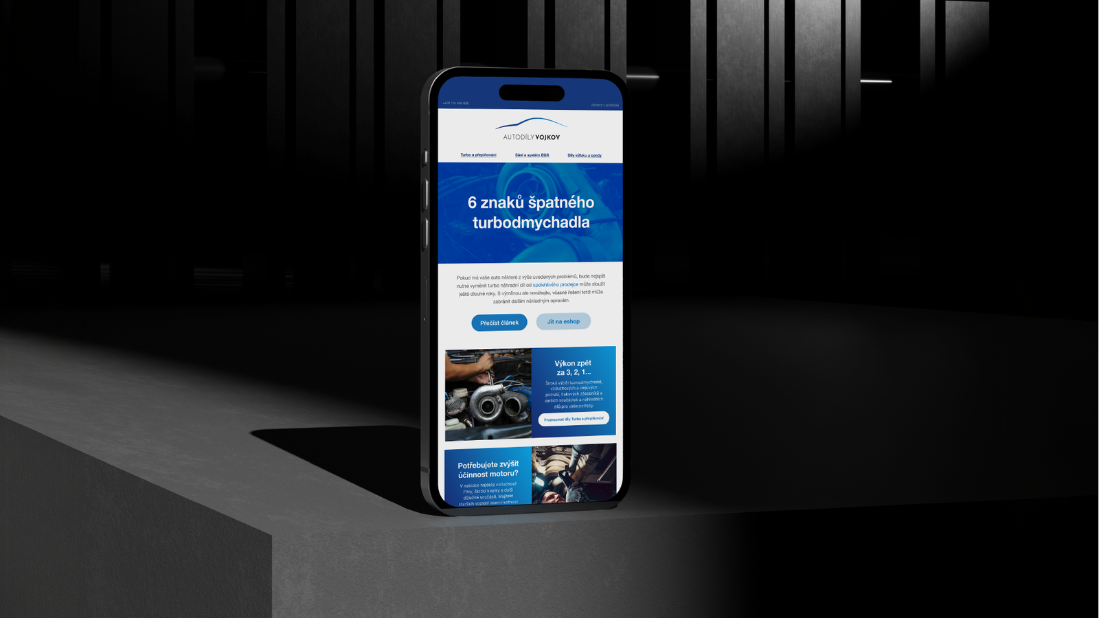 Autodíly Vojkov newsletter on a phone with an article about turbochargers