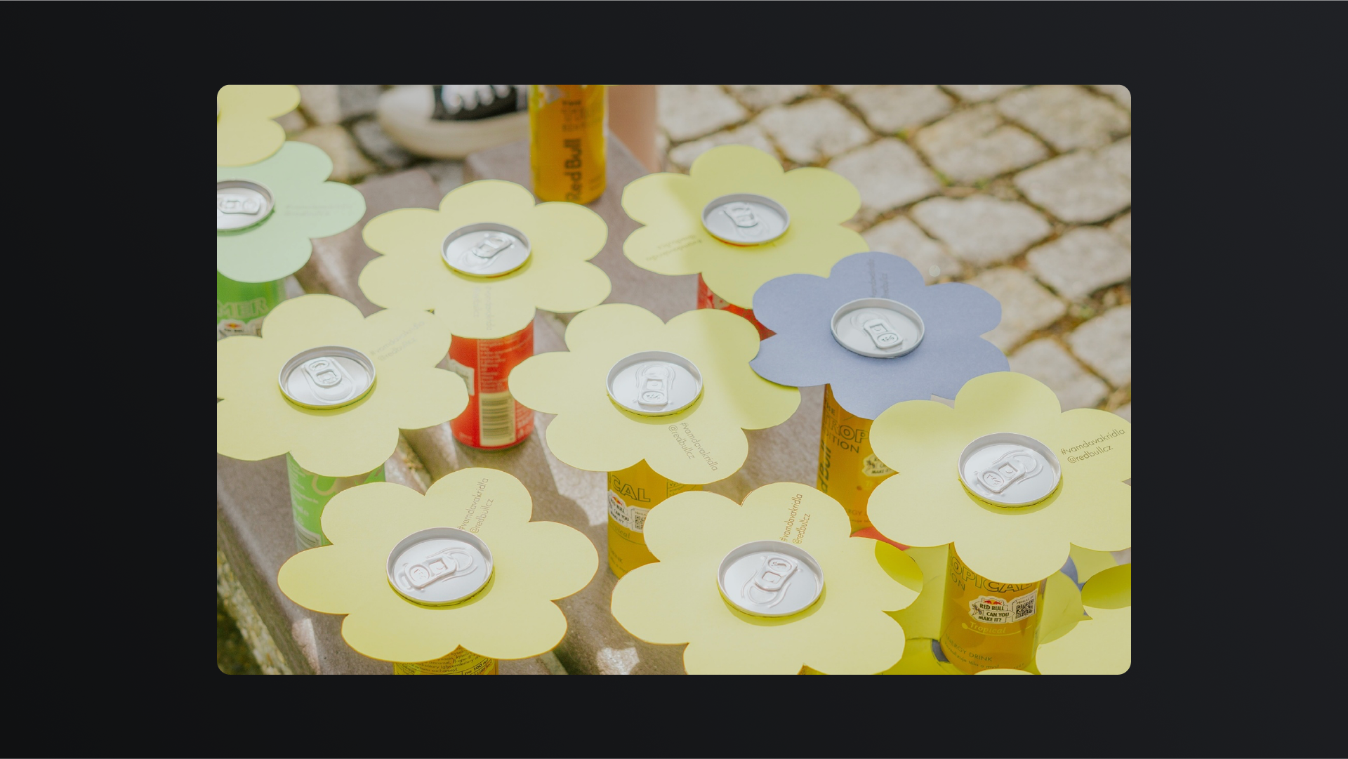 Paper flowers fitted onto Red Bull cans