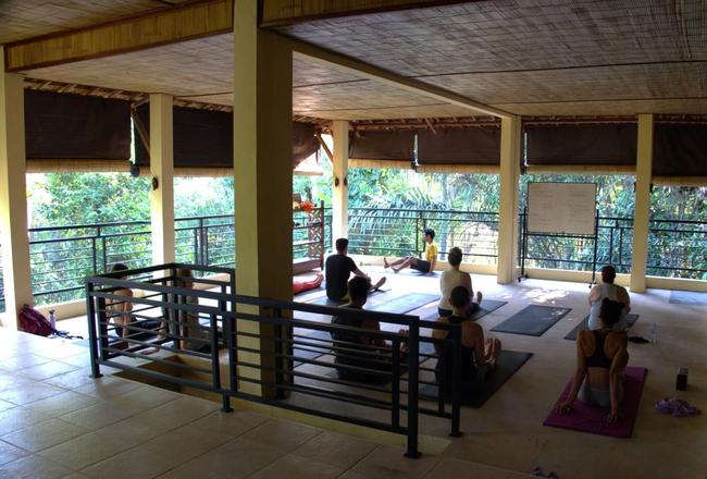 A retreat participant practicing yoga at Shanti Toya.