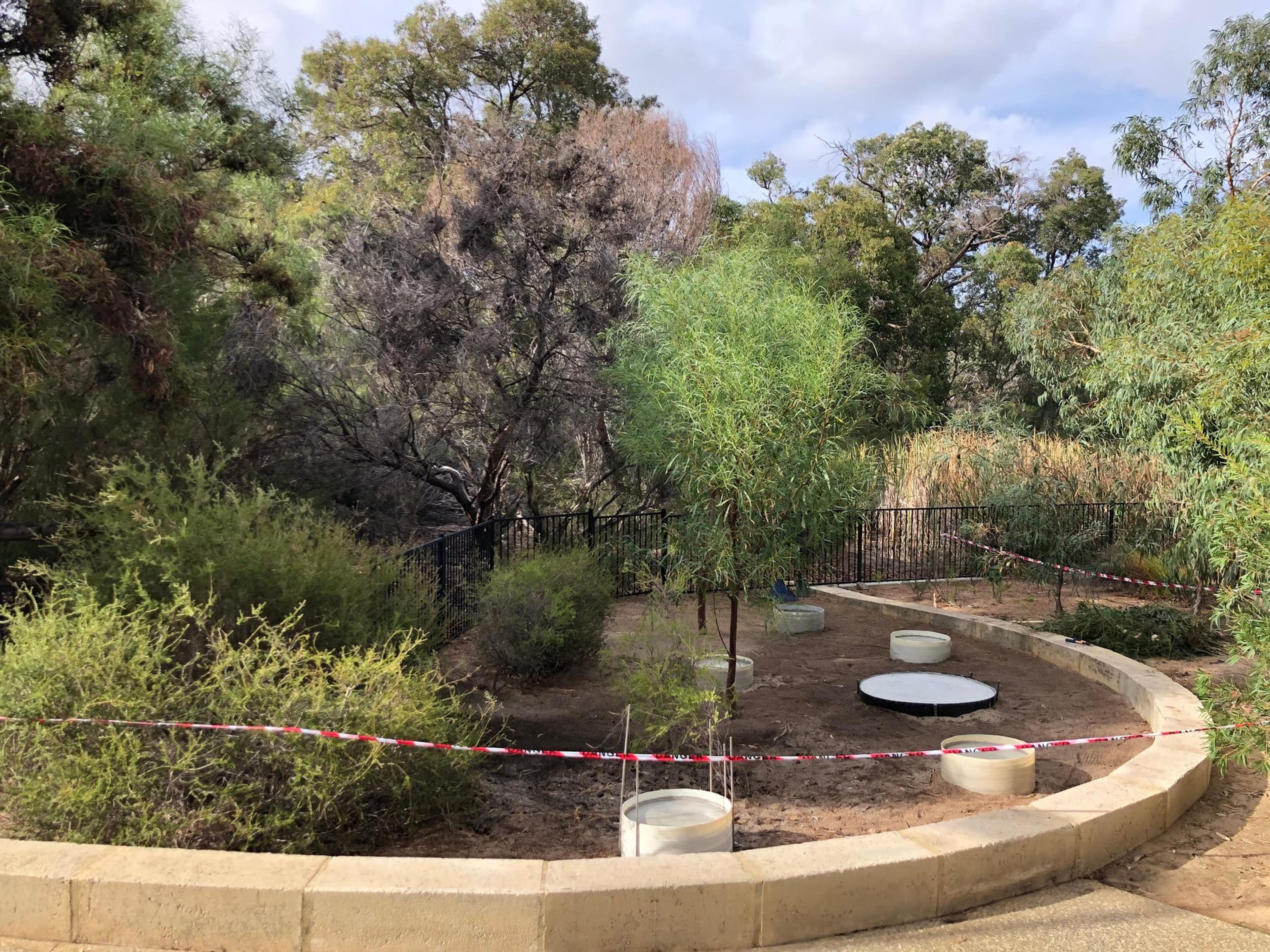 Concrete footings set out in a curved garden bed beside the hospital lake gardens