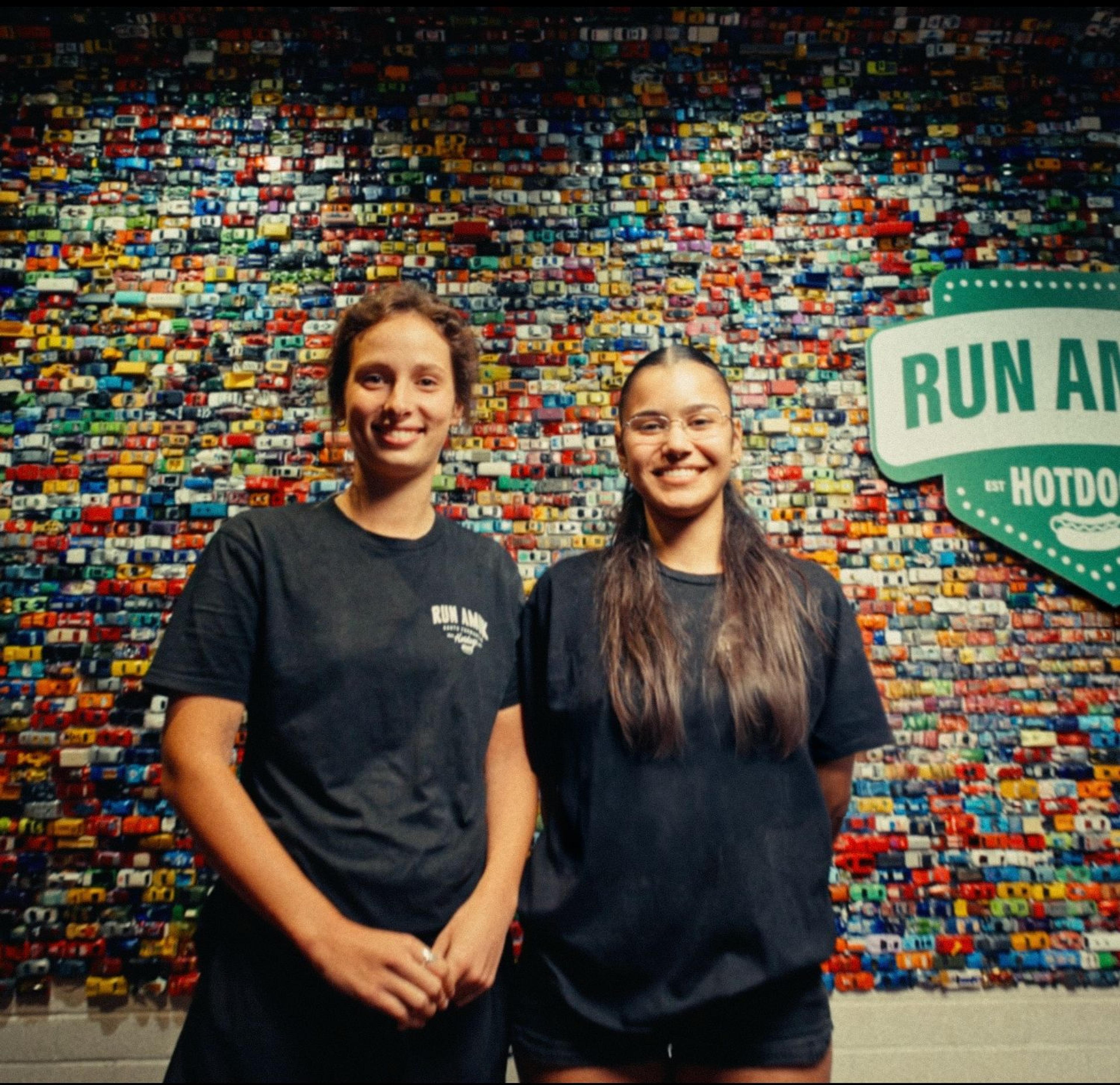Run Amuk Hotdogs staff in front of the shop’s toy-car wall