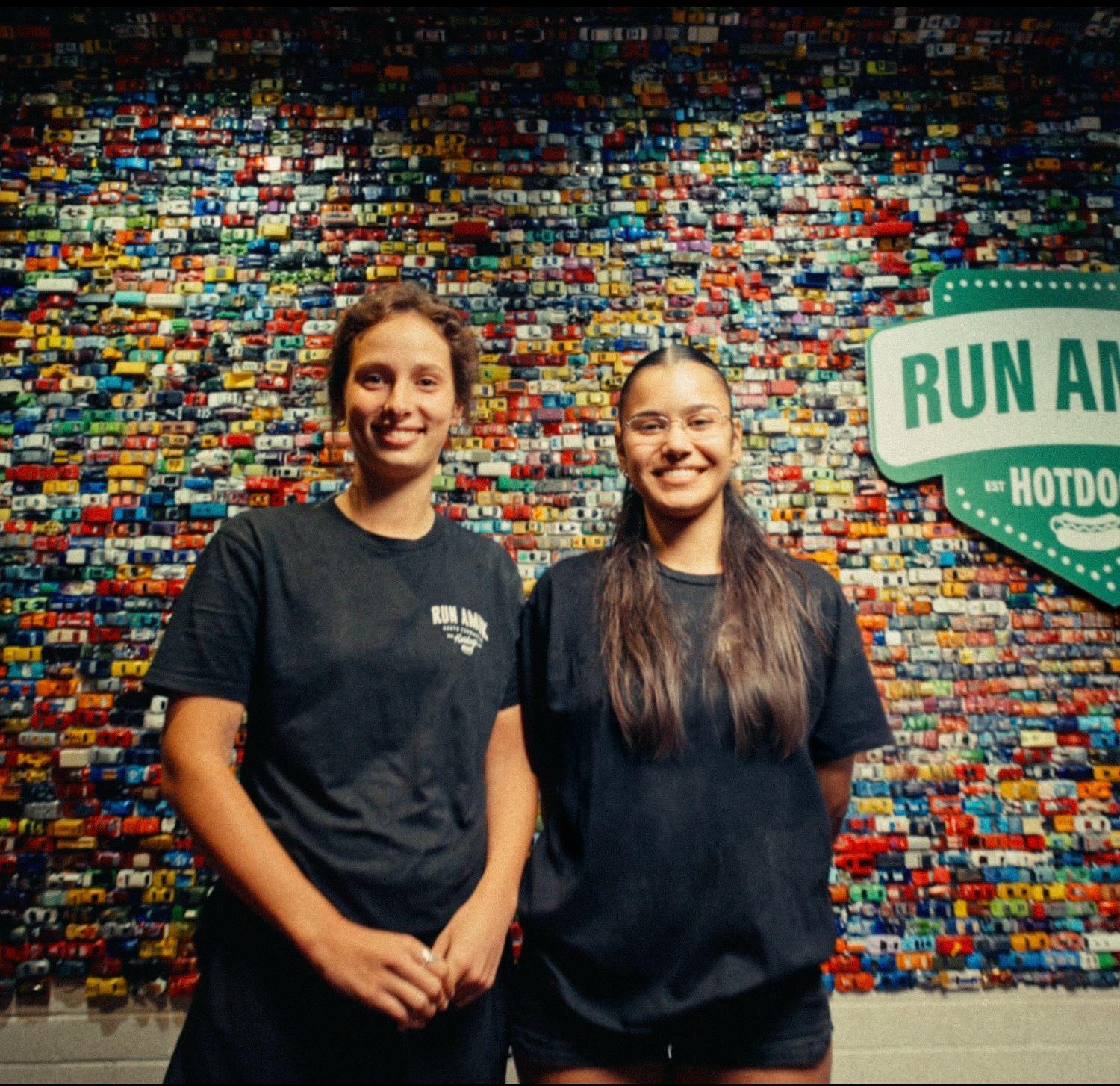 Run Amuk Hotdogs staff in front of the shop’s toy-car wall