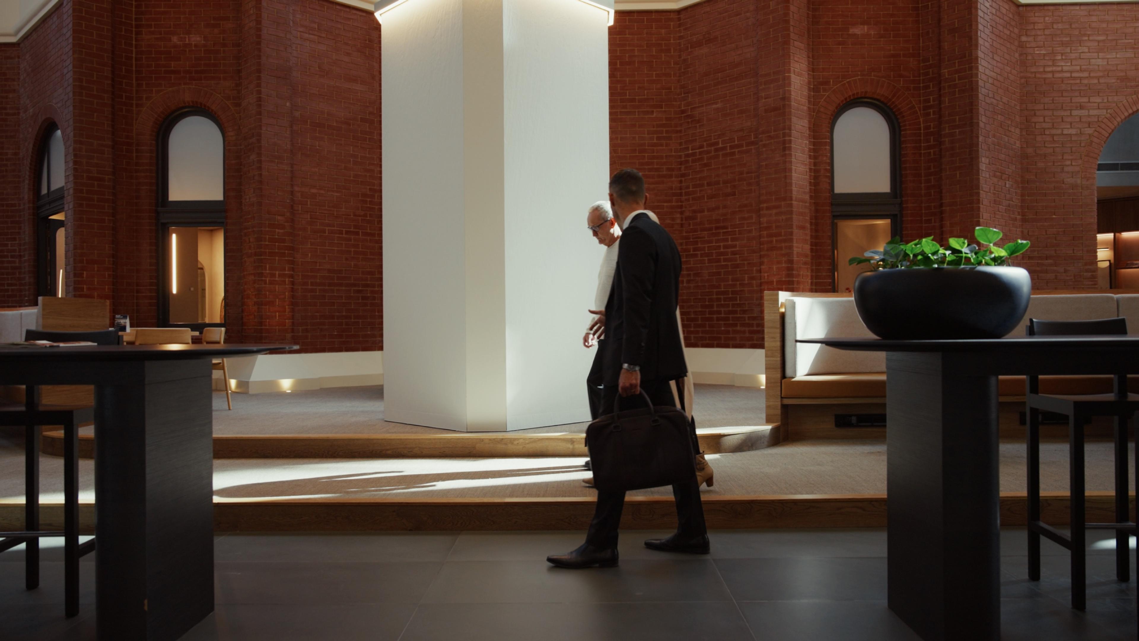 Jonathan Crabtree walking through the building’s atrium