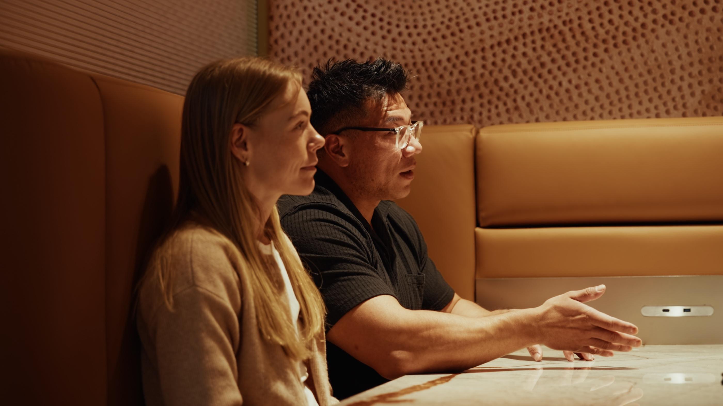 A Crabtree Legal lawyer talking with clients in a meeting booth