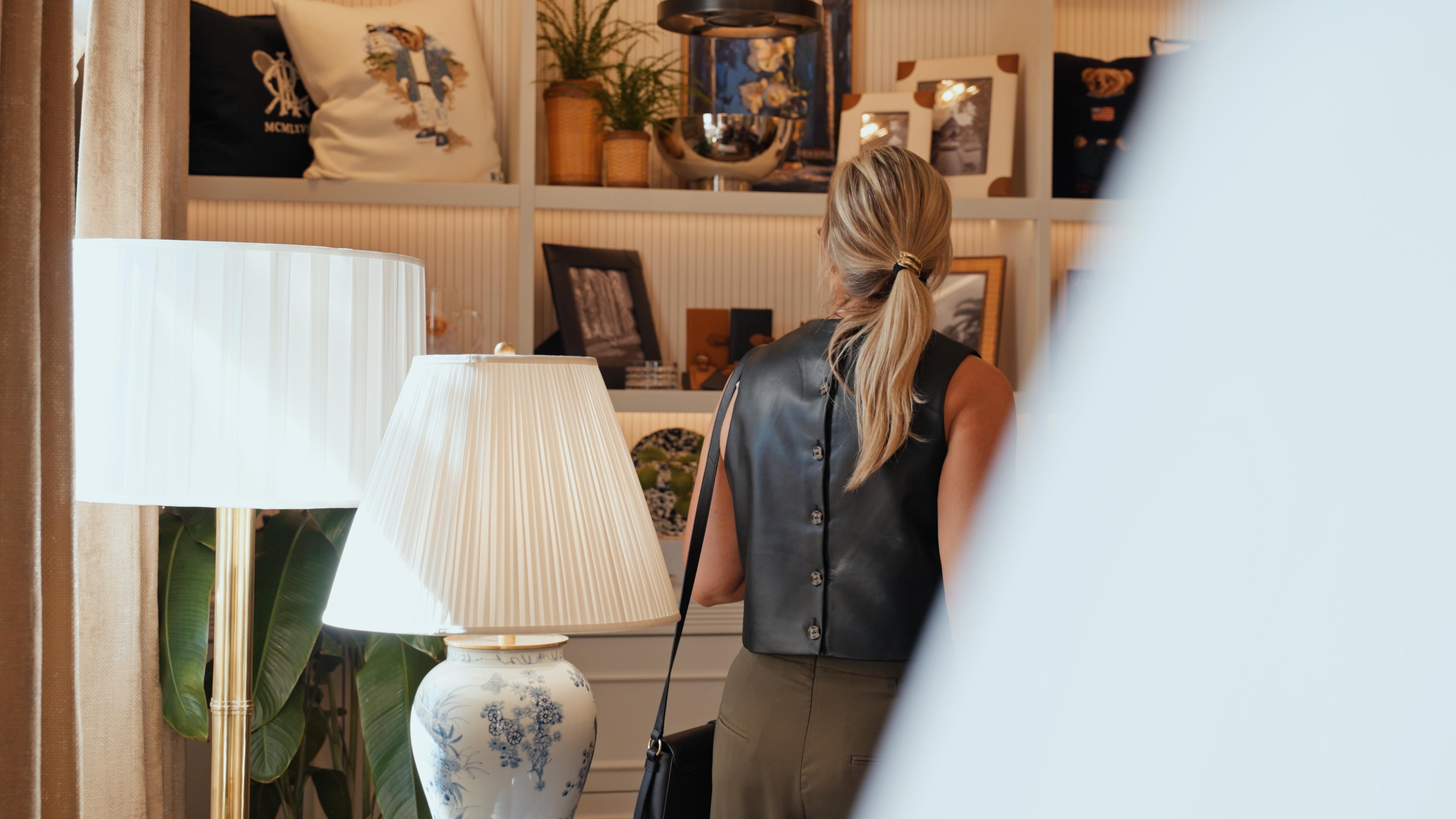 A visitor browsing the shelves of the Ralph Lauren Home gallery