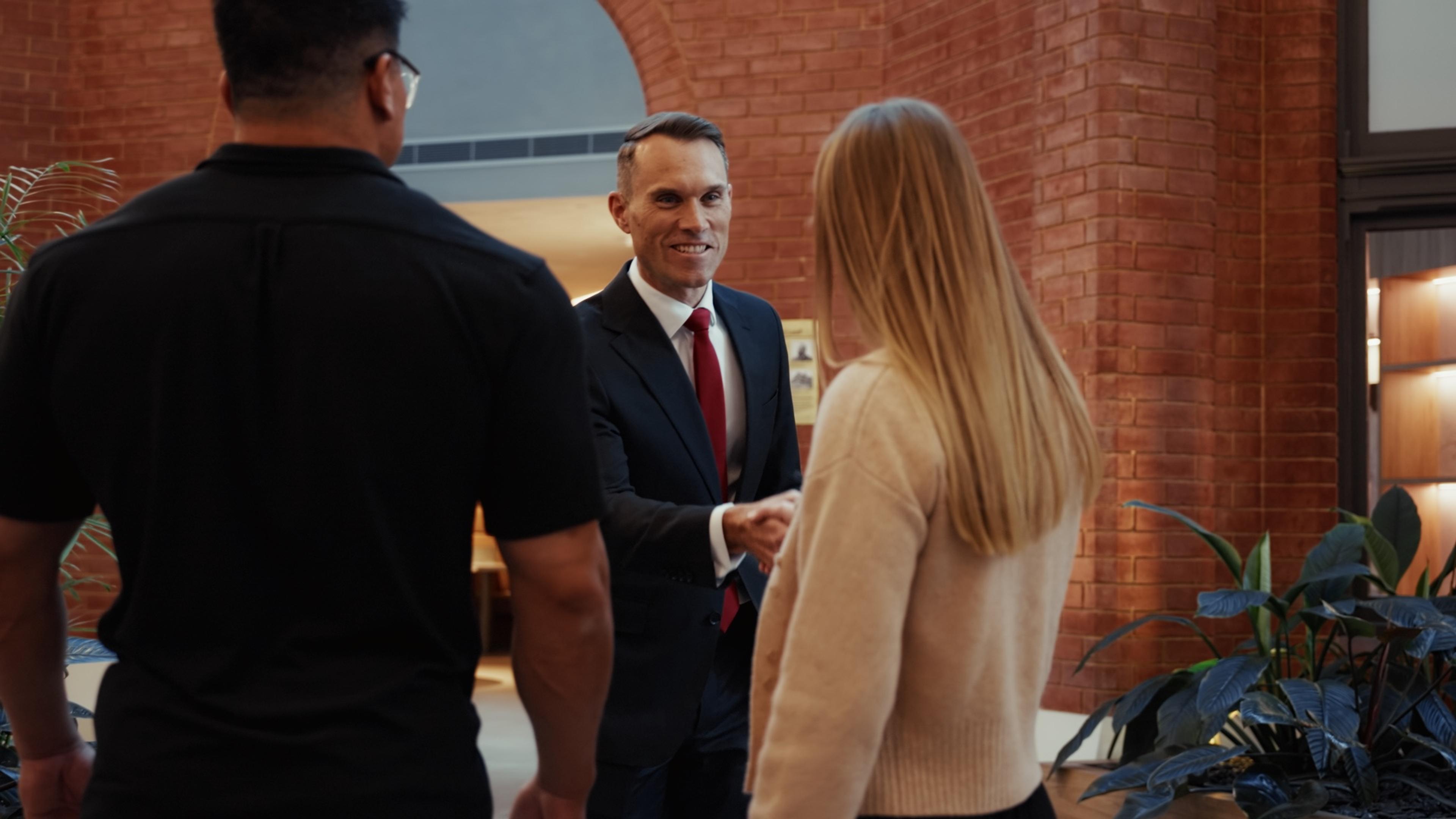 A Crabtree Legal lawyer greeting new clients with a handshake