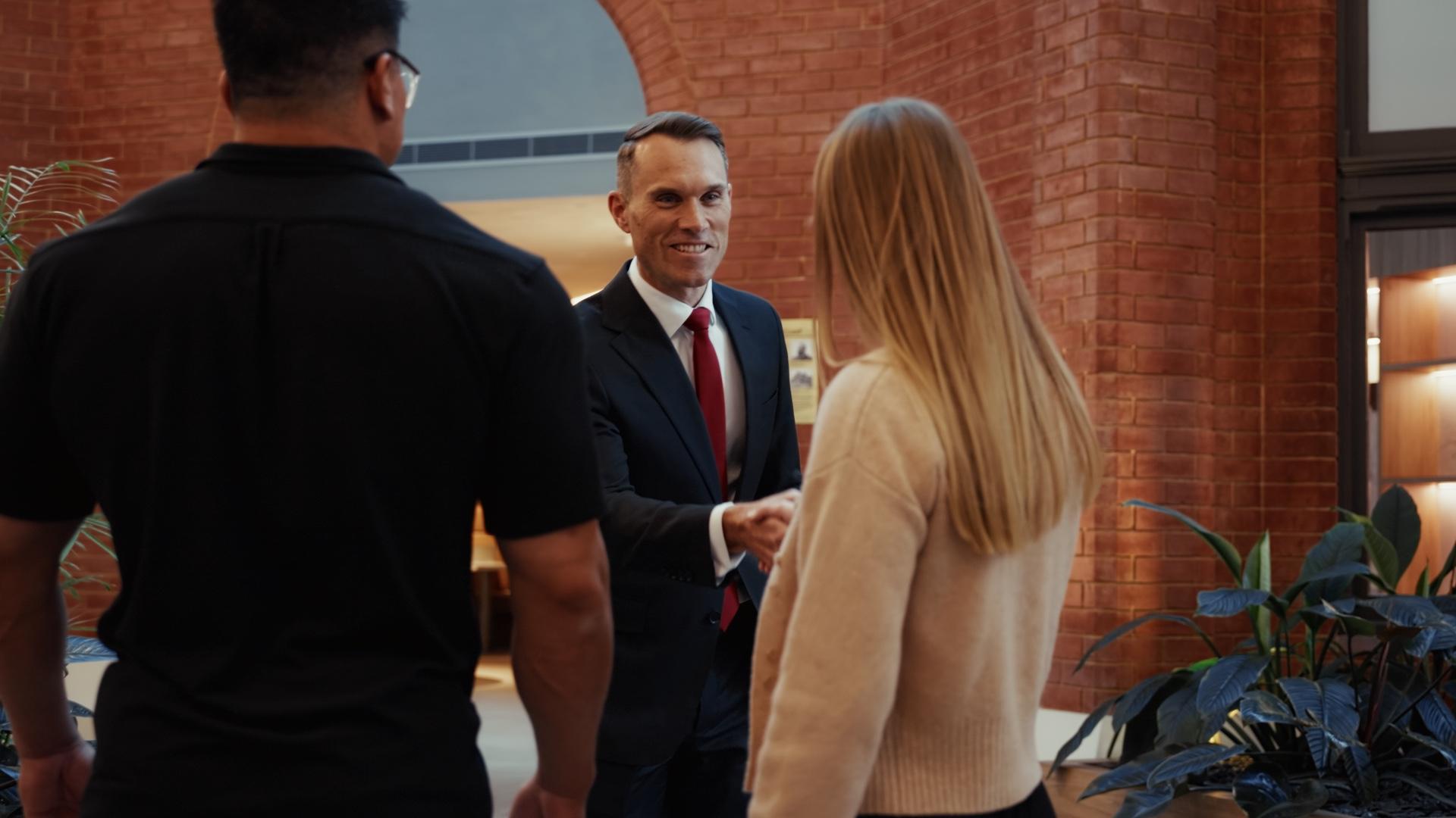 A Crabtree Legal lawyer greeting new clients with a handshake
