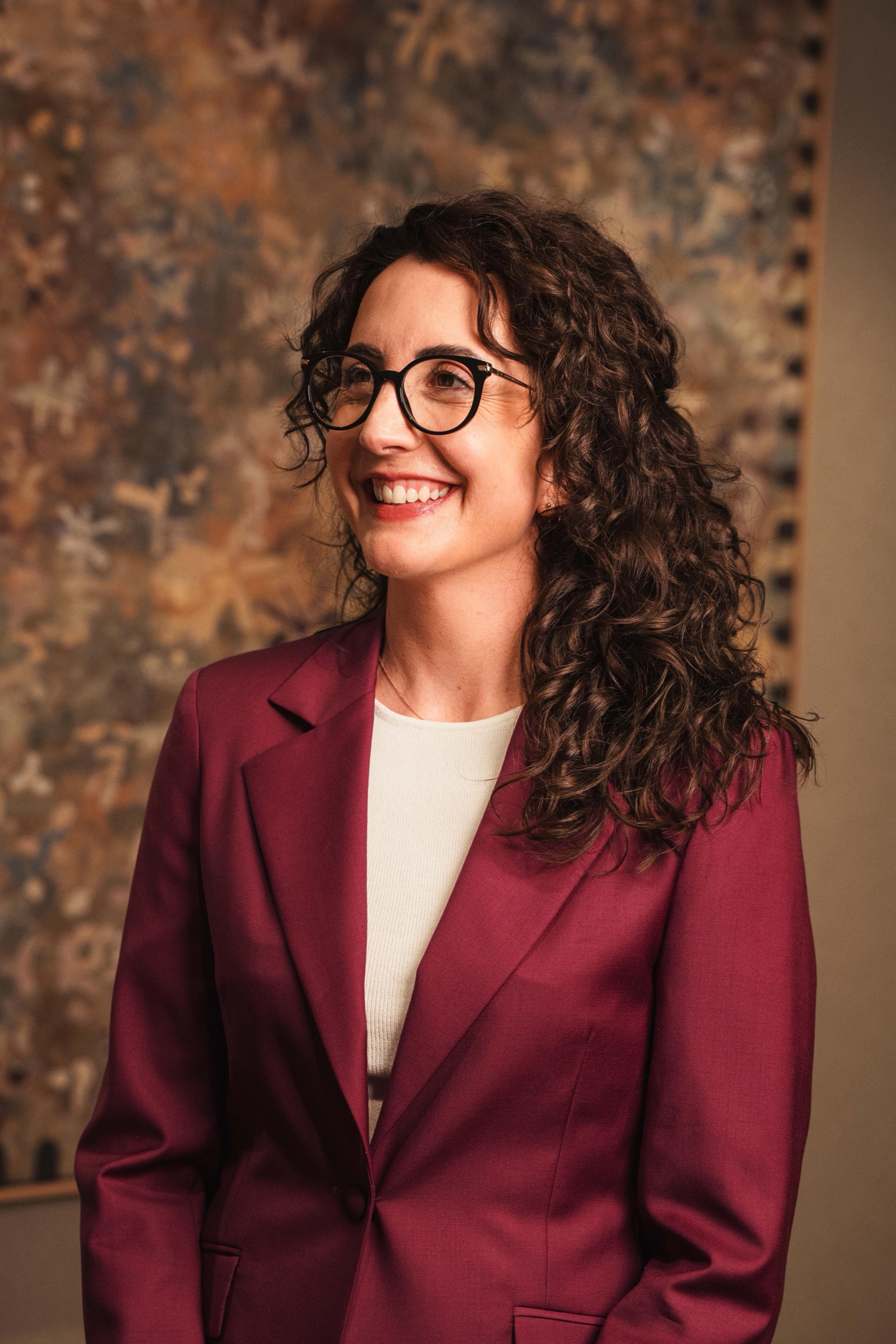 Portrait of an AKT Advisory founding partner in a plum blazer