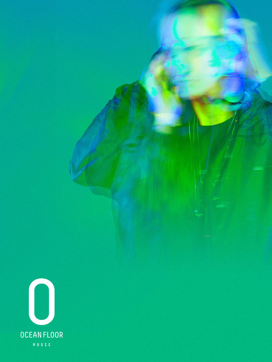 Campaign artwork: a DJ in green and aqua light with the Ocean Floor Music logo