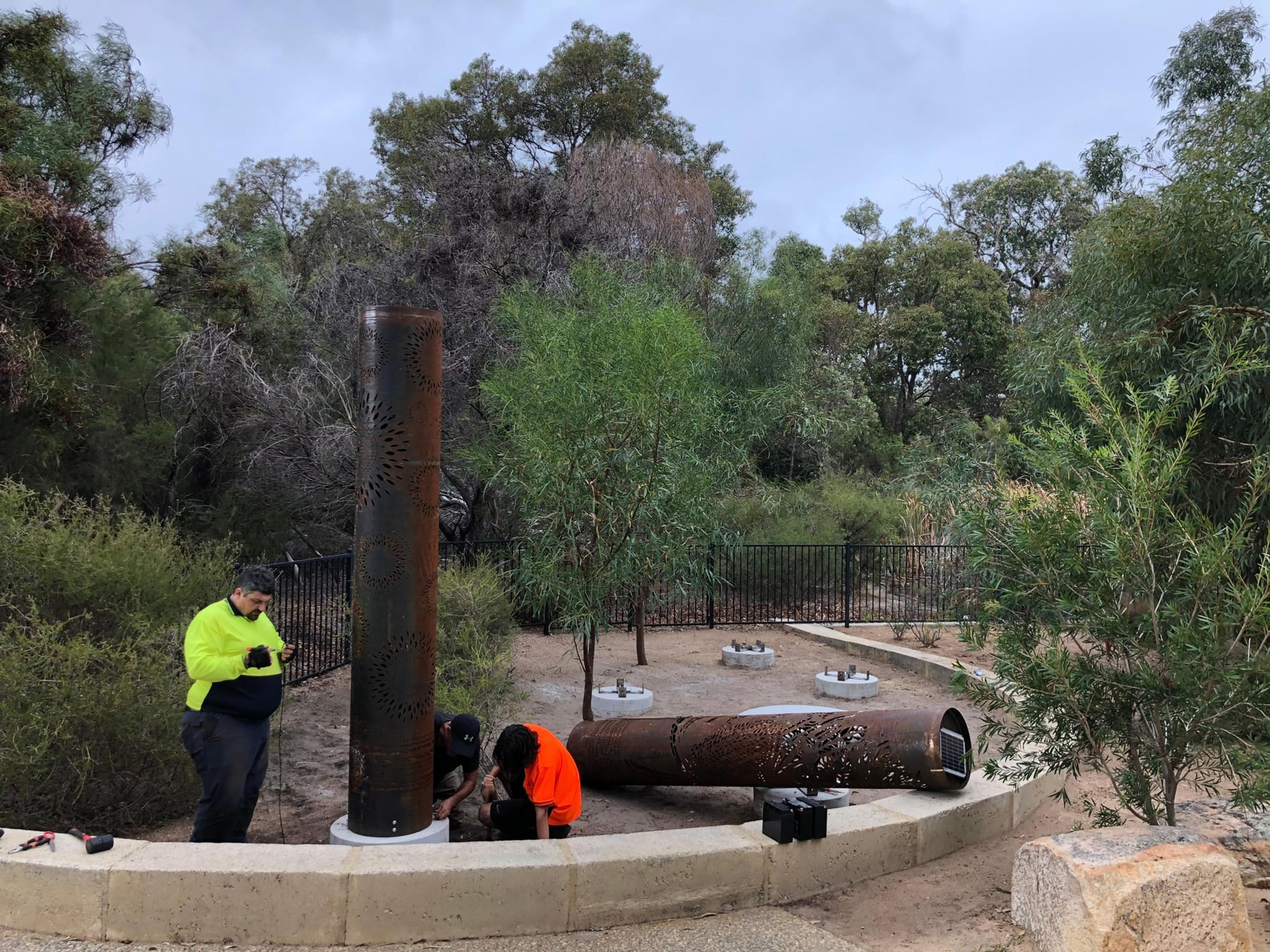 The first totem standing, with another lying ready beside its footing