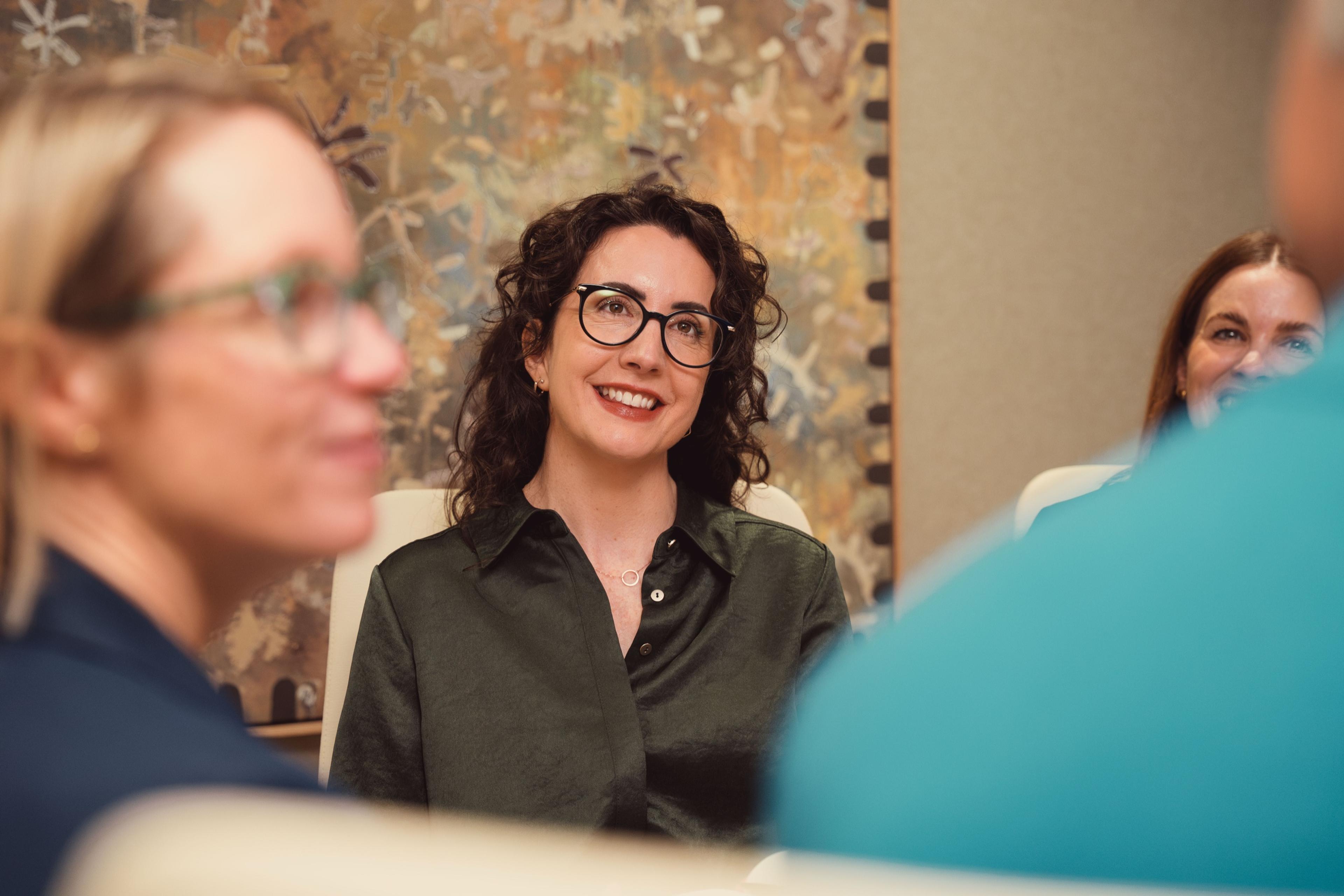 An AKT Advisory partner listening in a meeting