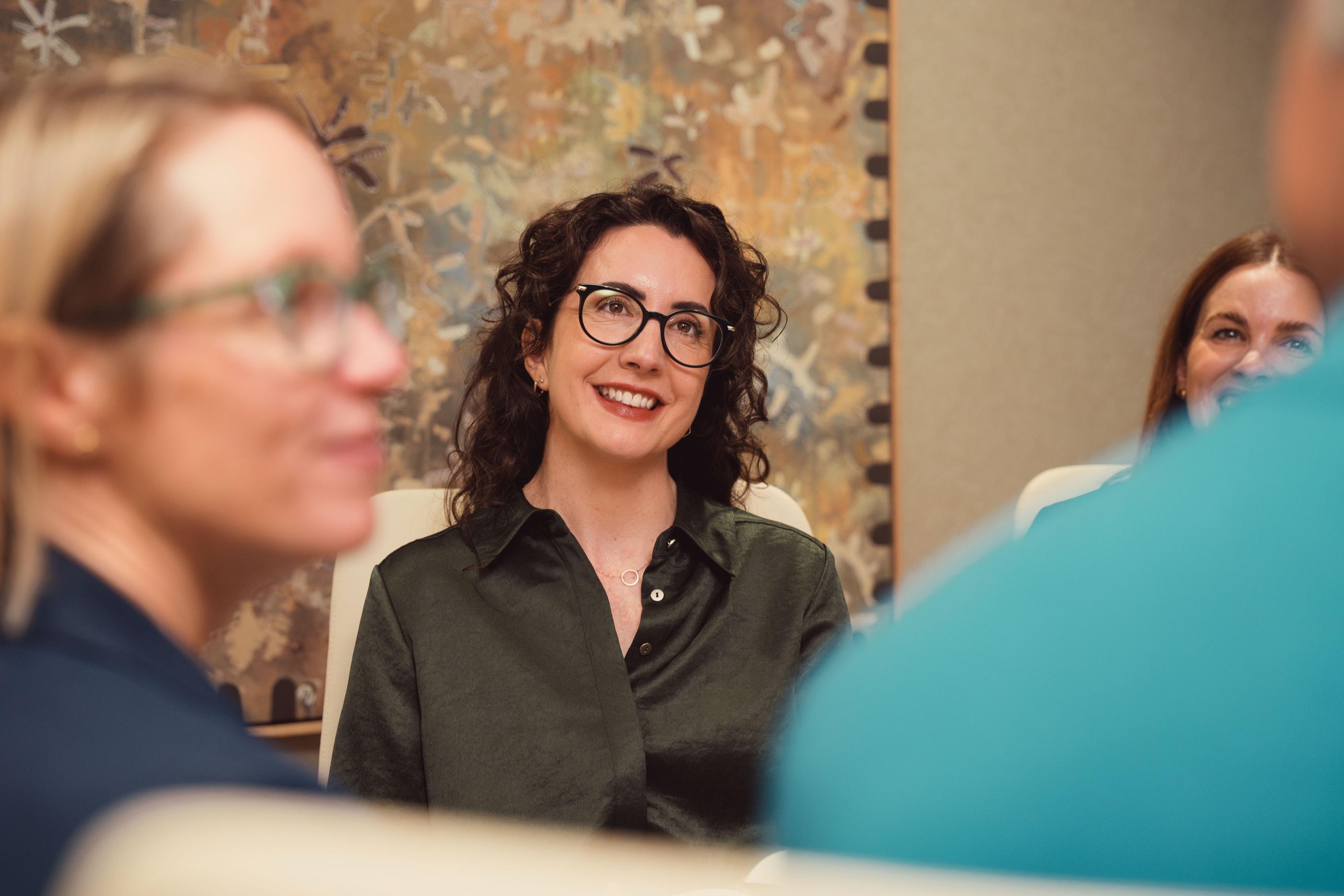 An AKT Advisory partner listening in a meeting